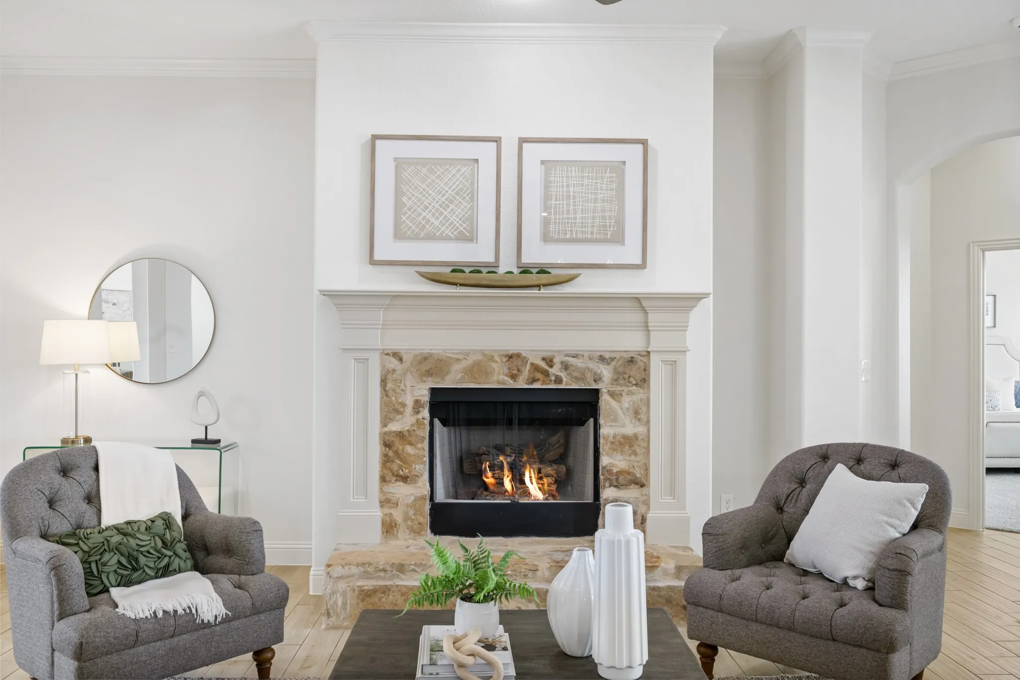 Fireplace featuring a stone facade and hearth, with a substantial mantelpiece