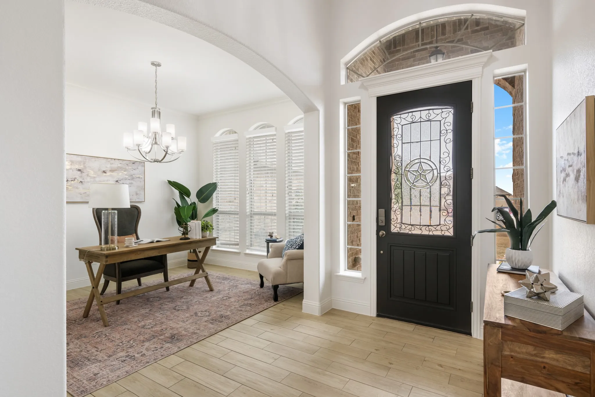 Entryway featuring a dark wood door with decorative glass, transom window, and sidelights