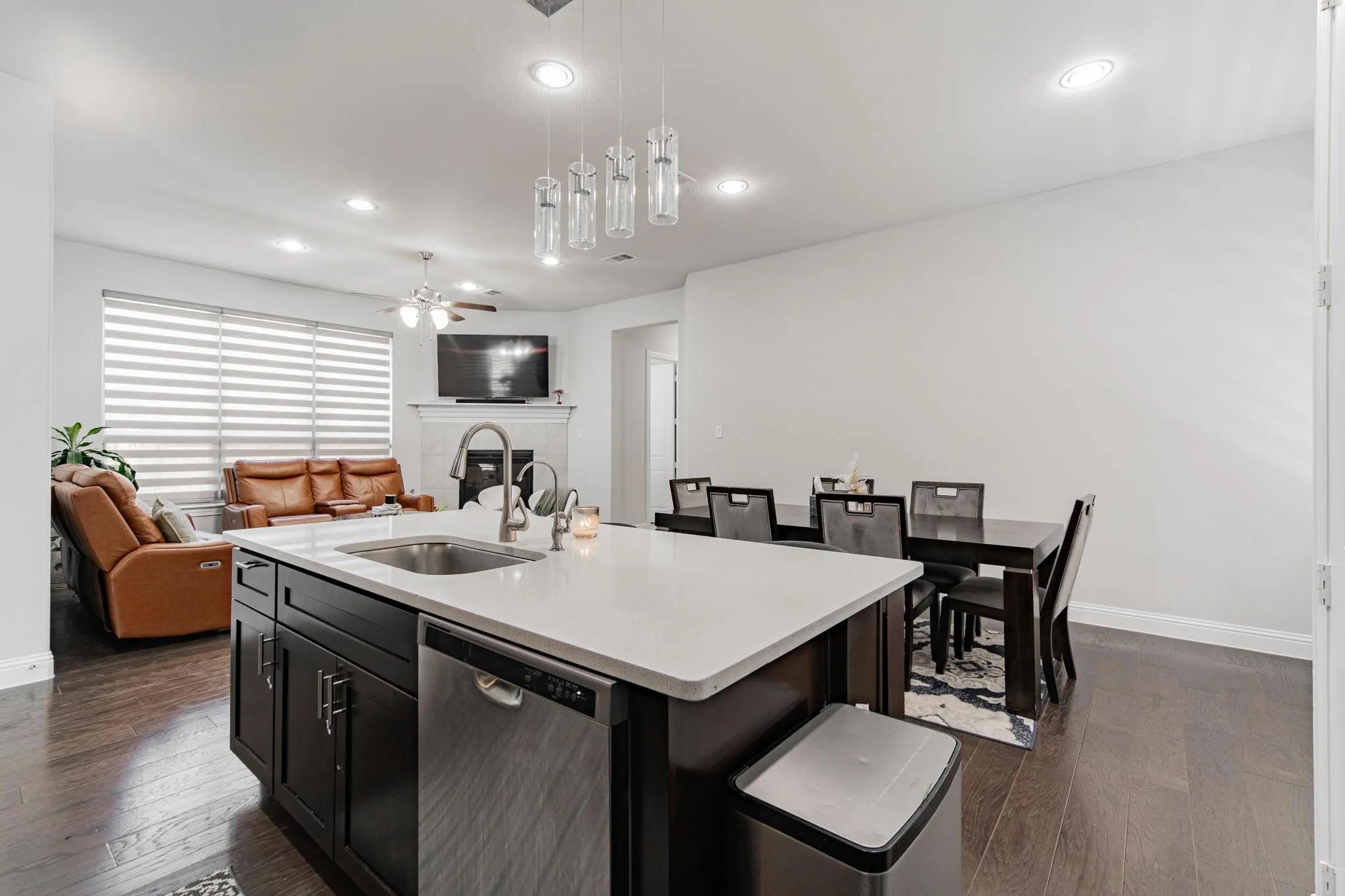 Kitchen island with an undermount sink, a dishwasher, and pendant lighting
