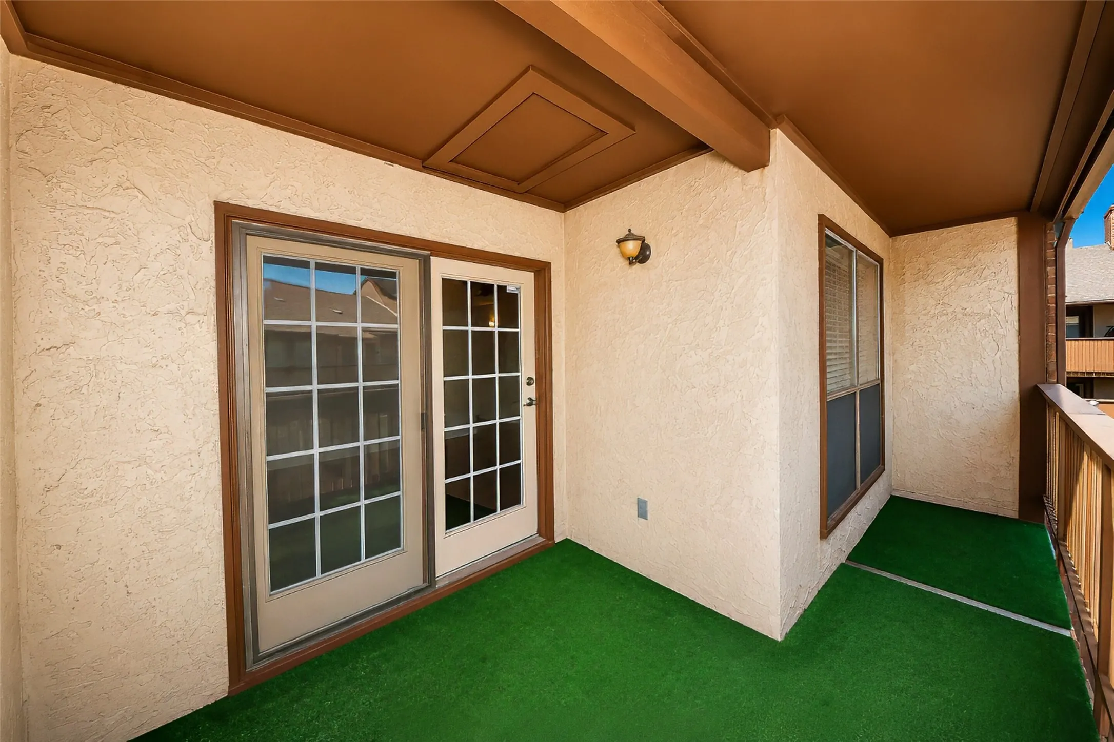 This balcony is covered and has plenty of space for a lounger or bistro table.