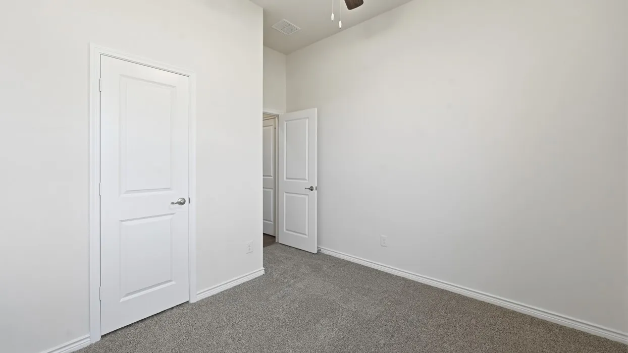 Neutral wall paint, plush carpeting, ceiling fan, and white panel doors