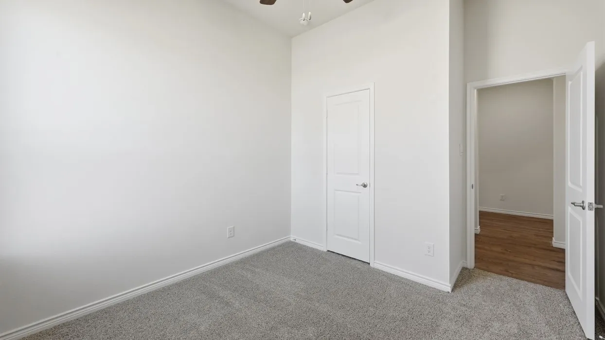 Light gray carpeting and tall white walls