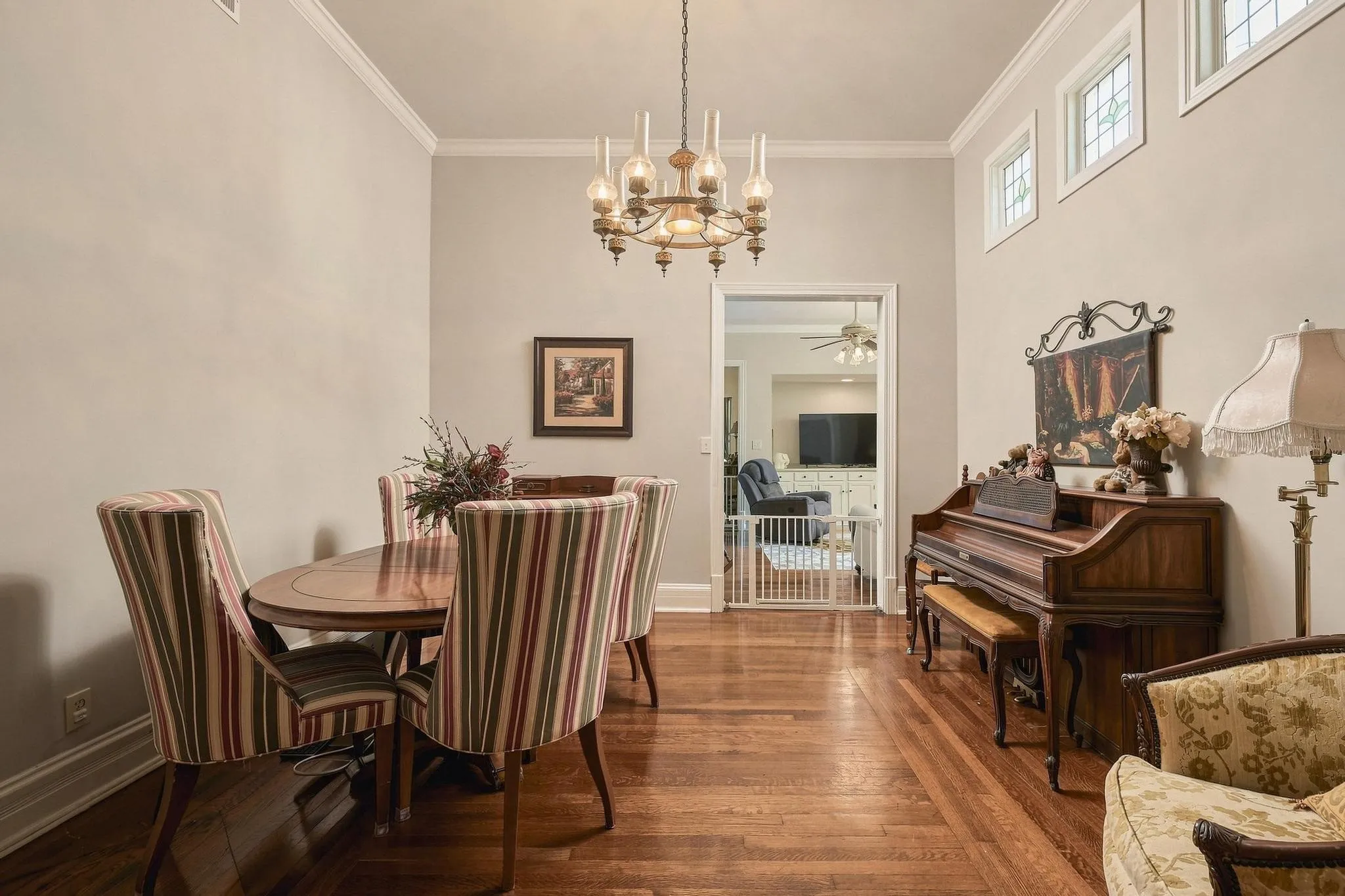 Dining room located between the kitchen and the living room with beautiful hardwoods