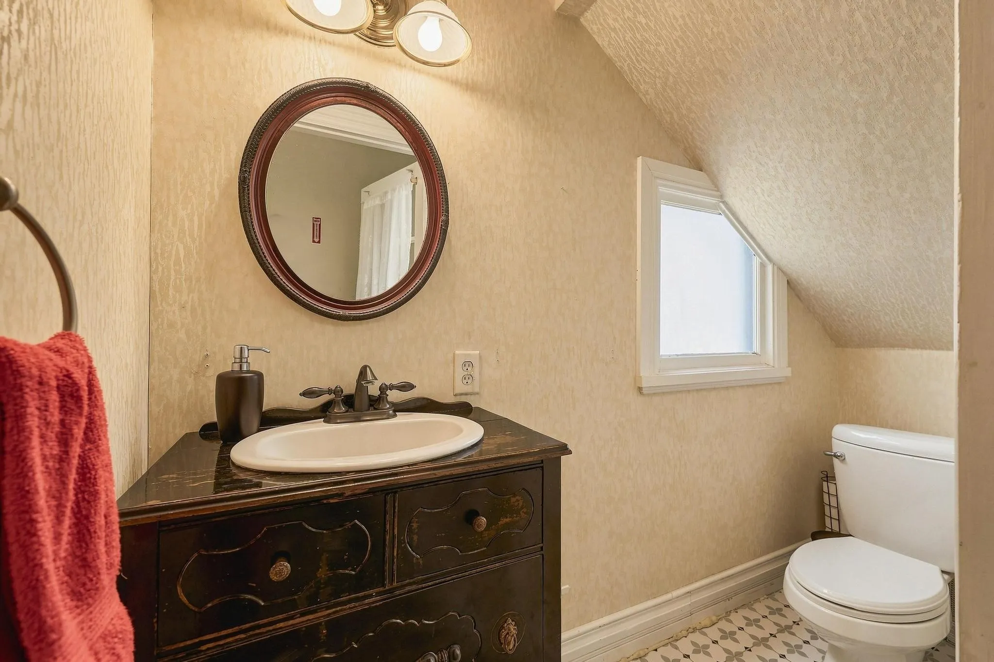 Half bath beneath the stairs with French door entry