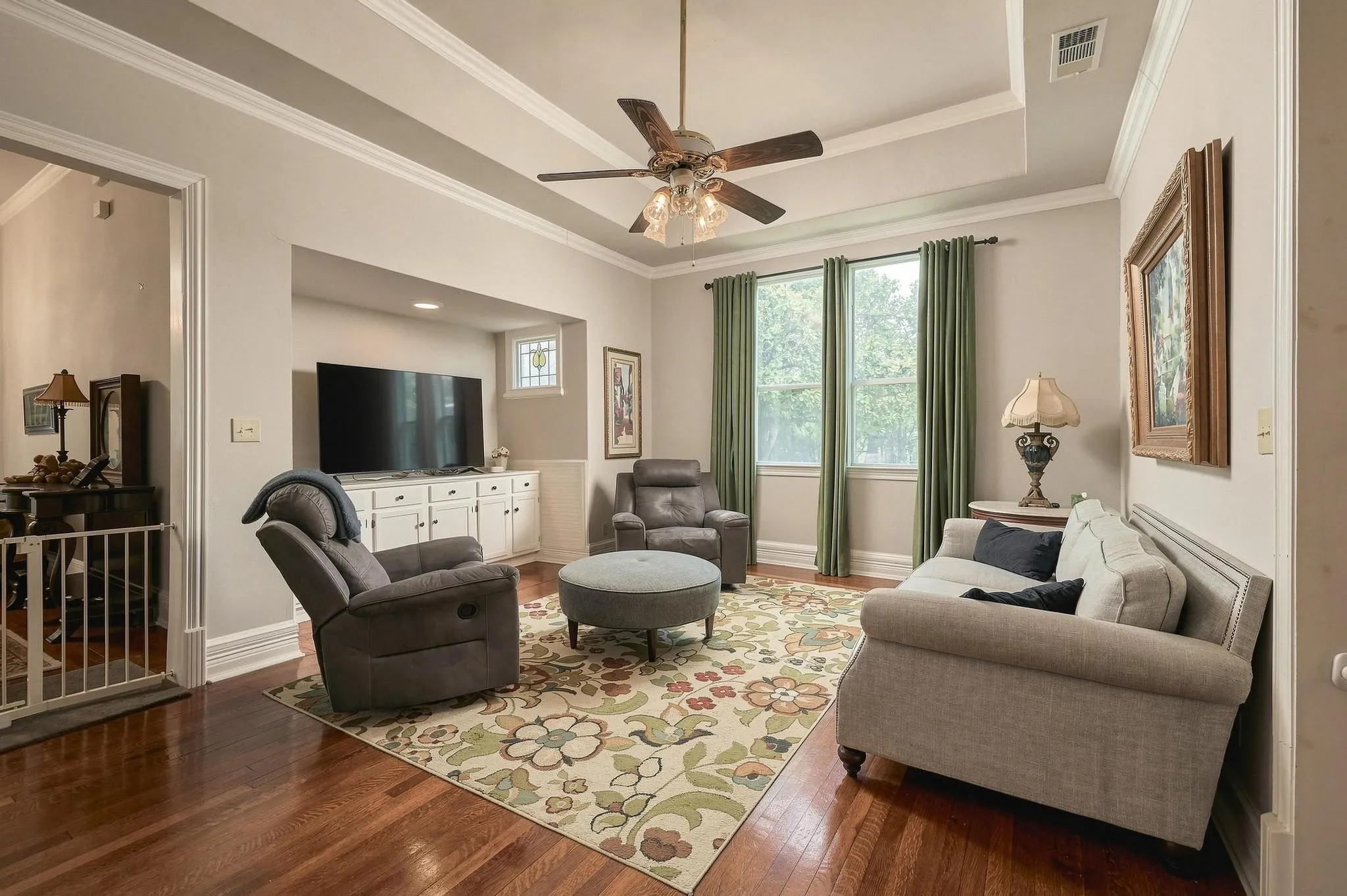 Inviting living room with gas log dual sided fireplace and entertainment inset