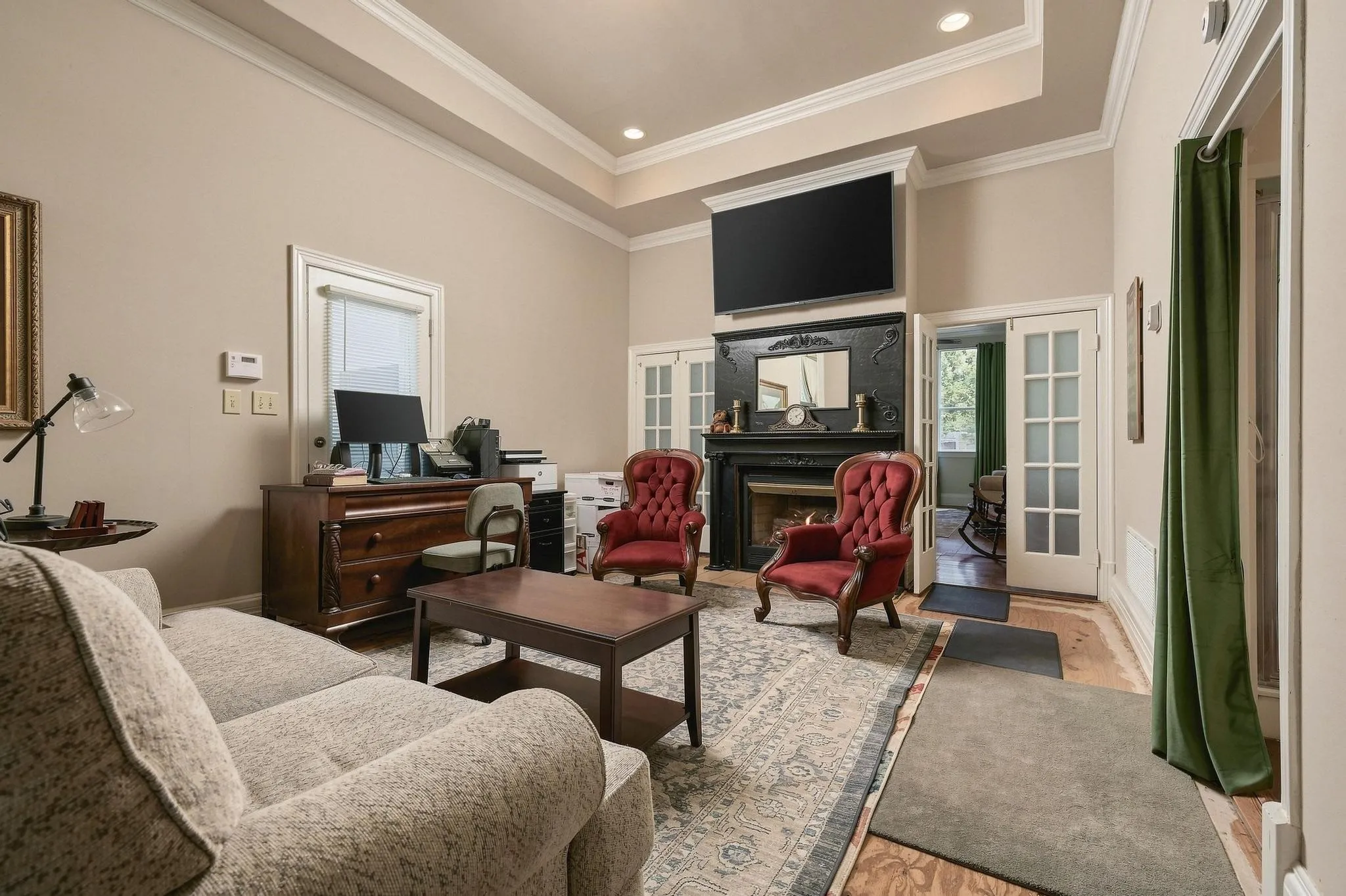 Primary Bedroom sitting area with view of dual sided fireplace