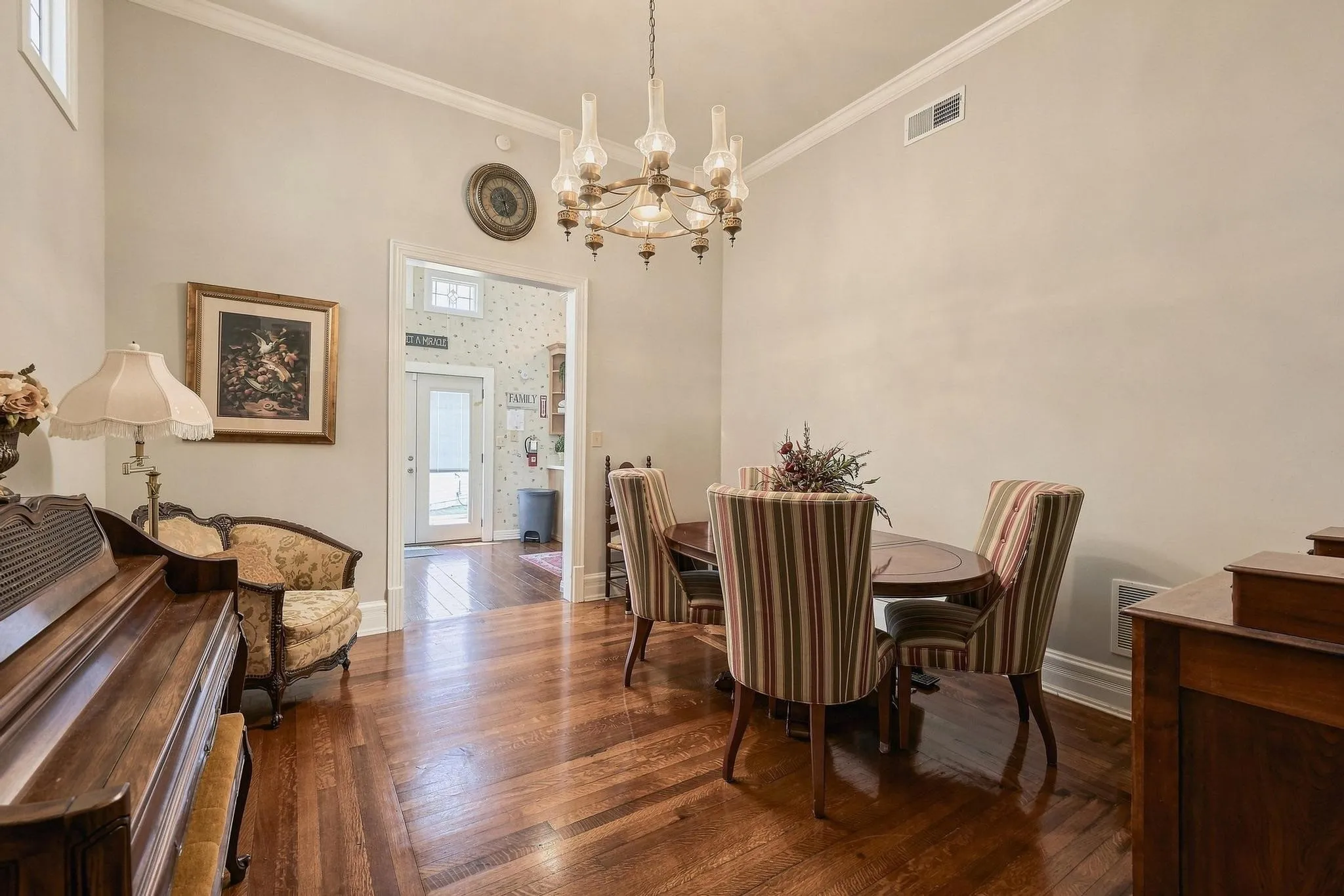 Dining room located between the kitchen and the living room with beautiful hardwoods