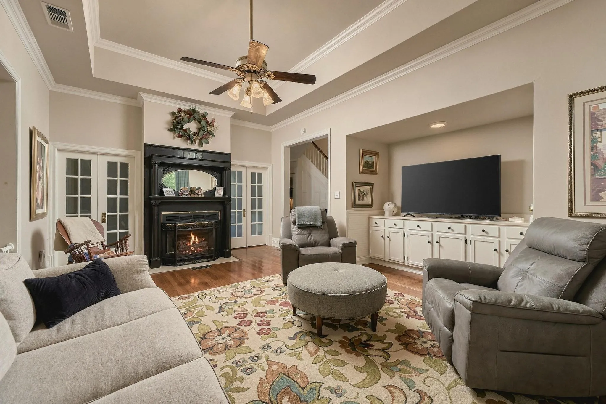 Inviting living room with gas log dual sided fireplace and entertainment inset