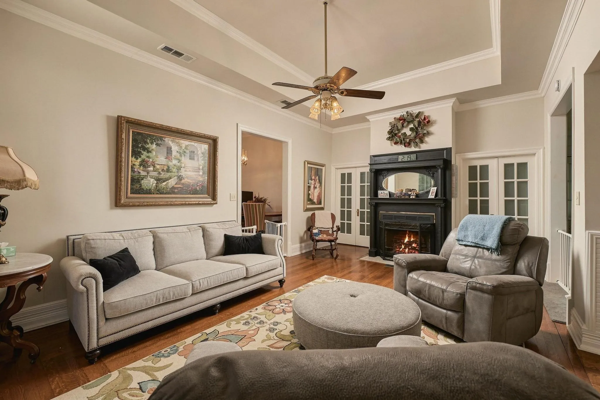 Inviting living room with gas log dual sided fireplace and entertainment inset