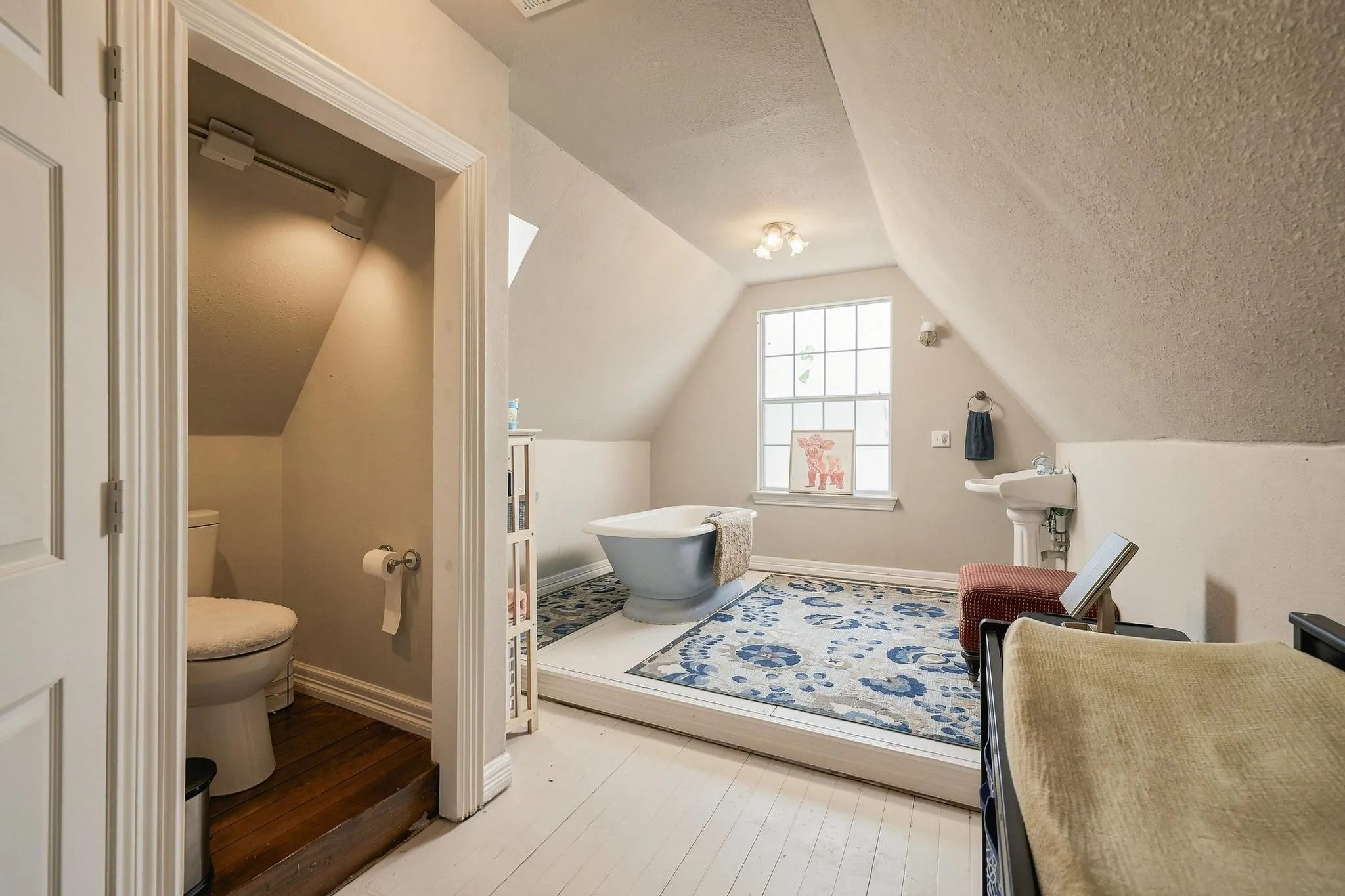 Large second floor full bathroom with private area and step in Antique flute bottom cast iron tub that is original to the home