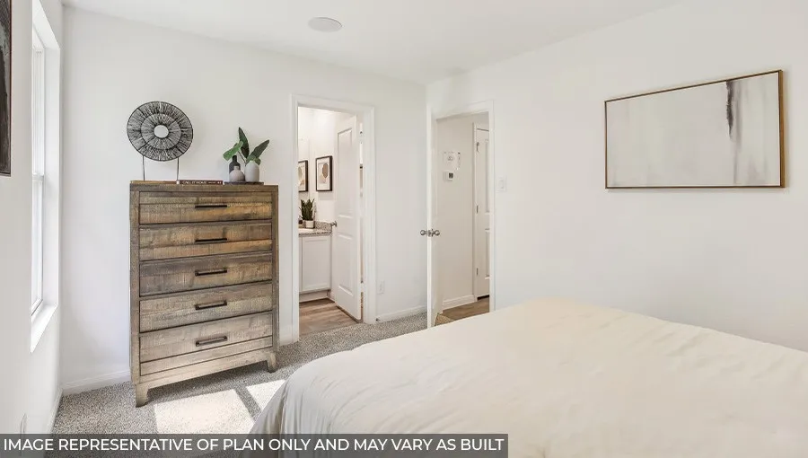 Neutral wall colors, carpeted flooring, and a recessed ceiling speaker