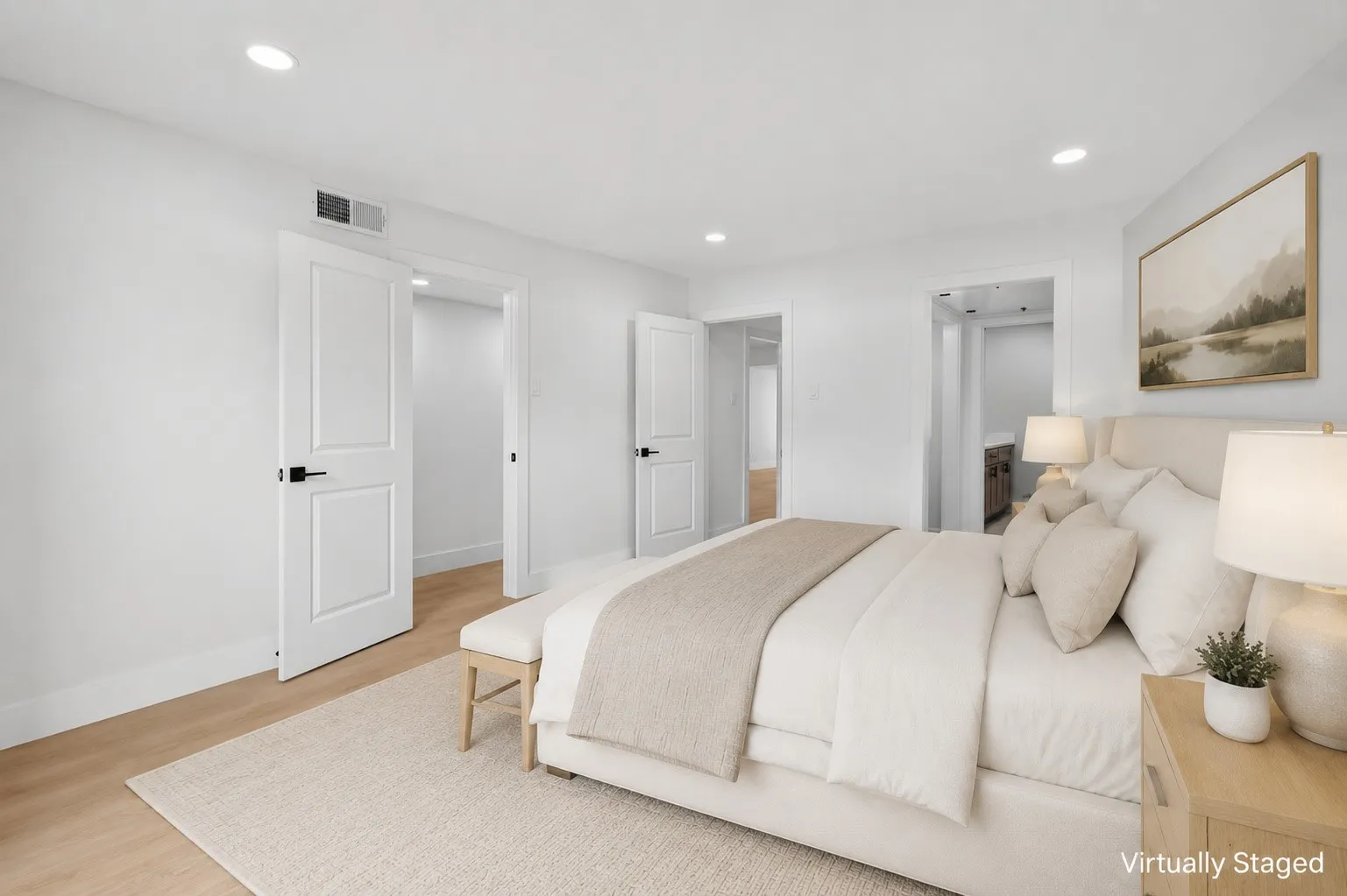 Recessed ceiling lighting, wood-finish flooring, two-panel interior doors with matte black hardware, and a neutral color palette