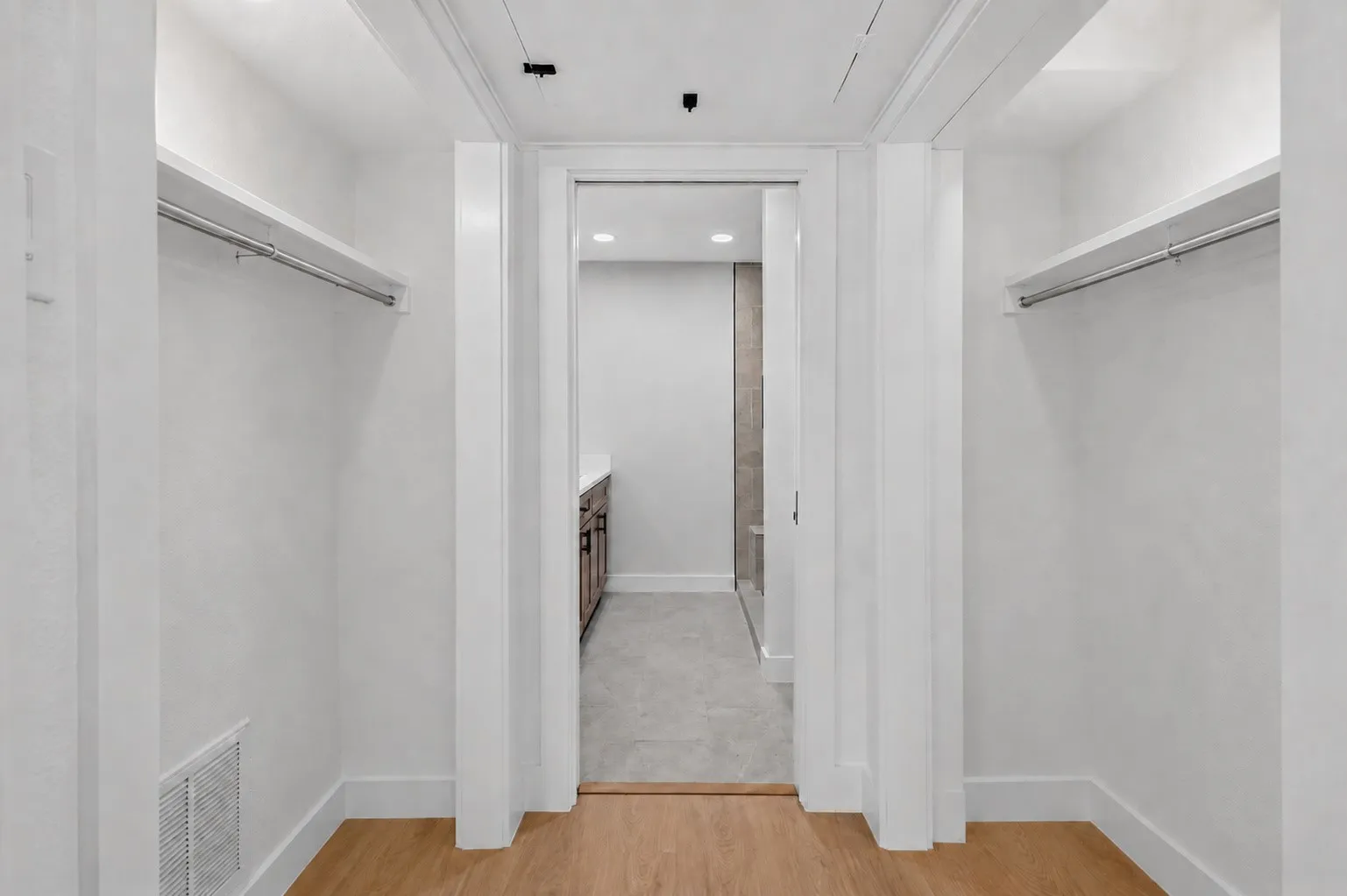 Walk-in closet with integrated shelving and hanging rods