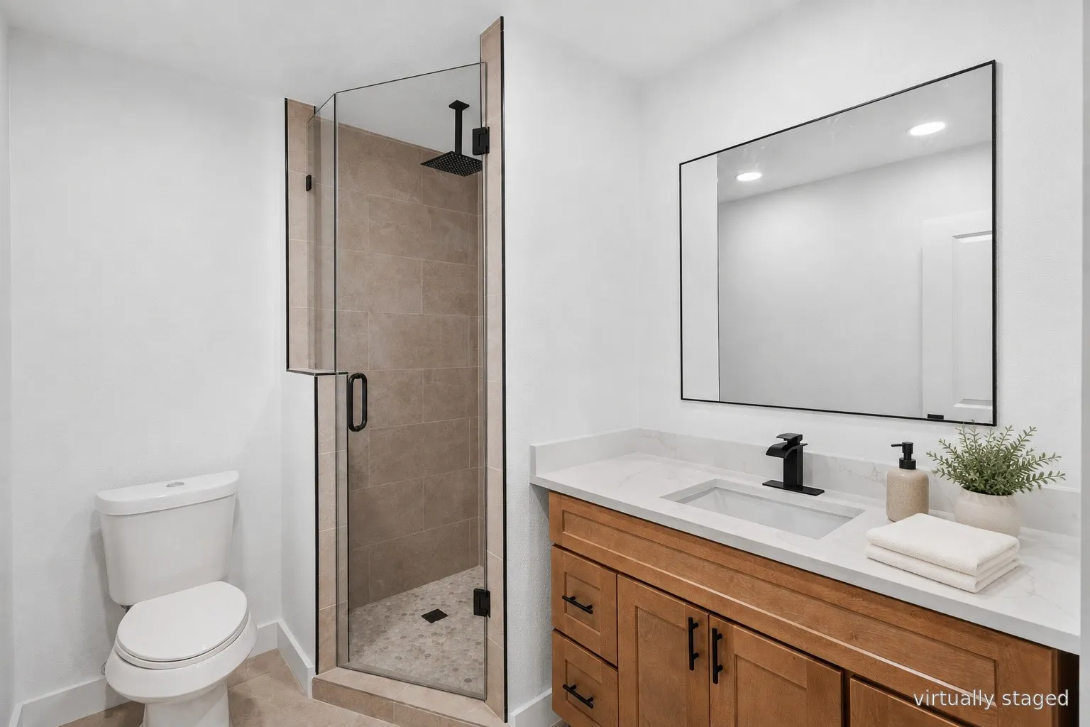 Modern bathroom featuring a wood-finish vanity with dual drawers, white quartz countertop, rectangular vessel sink, and matte black wall-mounted faucet