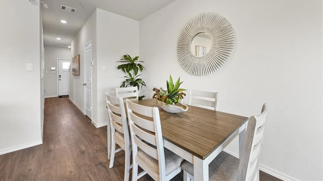 Wood-finish flooring throughout, recessed lighting, and a white interior door with hardware