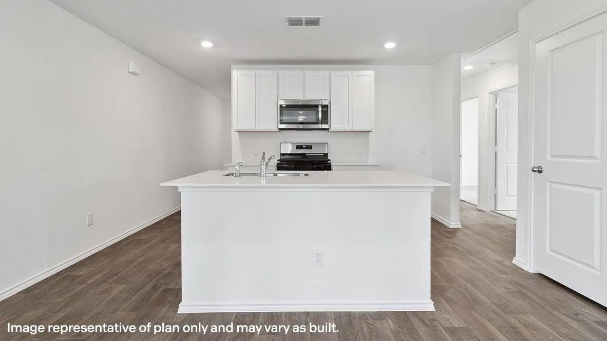 Kitchen featuring an expansive island with an undermount sink, white cabinetry, stainless steel appliances, and wood-finish flooring