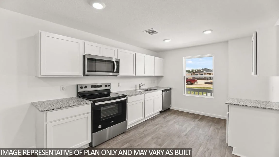 Modern kitchen featuring white cabinetry, stainless steel appliances, wood-finish flooring, recessed lighting, and speckled countertops