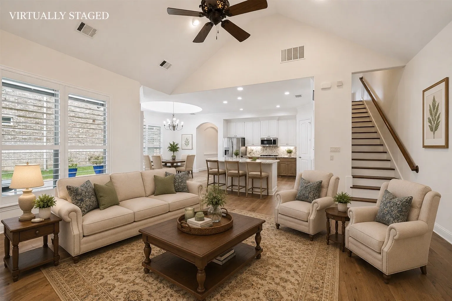 The heart of the home features an open-concept design with soaring vaulted ceilings, rich hardwood floors, a spacious gourmet kitchen with a large center island, and seamless flow into the breakfast nook and family room—perfect for everyday living and entertaining.