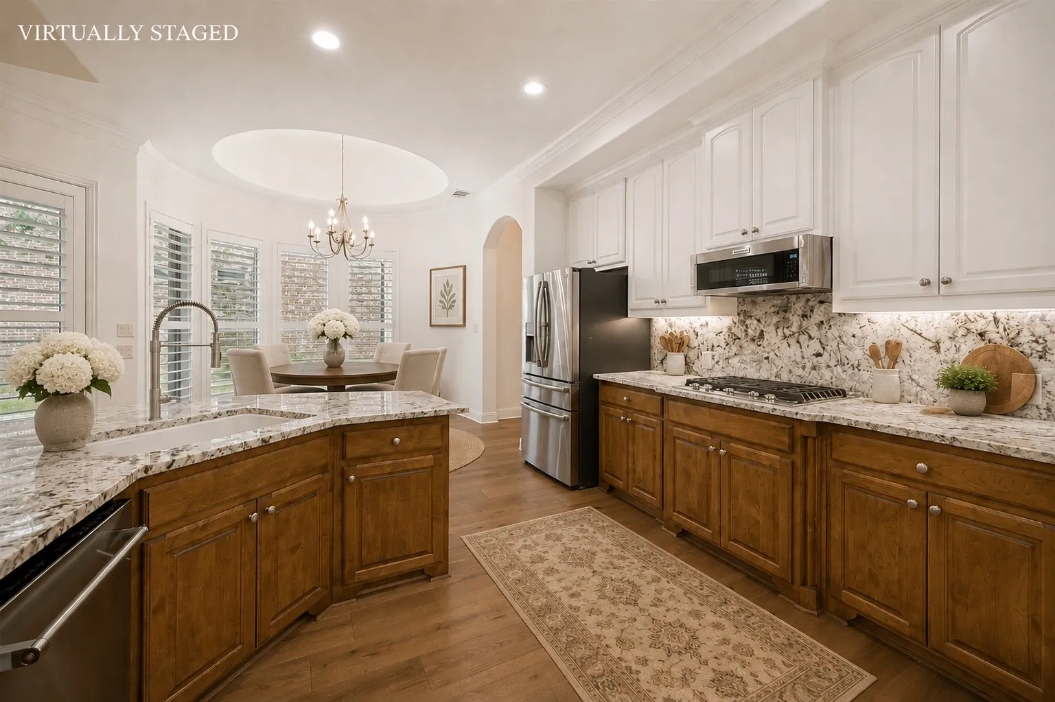The chef's kitchen is designed to impress with abundant custom cabinetry, granite countertops, a designer tile backsplash, stainless steel appliances, a gas cooktop, and generous prep space—perfect for entertaining and everyday living.