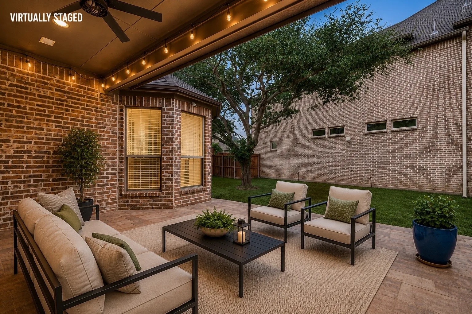 Enjoy year-round outdoor living on the expansive covered patio, complete with a ceiling fan, café string lighting, and ample space for dining and entertaining. The beautifully landscaped backyard offers lush green space and mature shade trees, creating a peaceful retreat for family and friends.