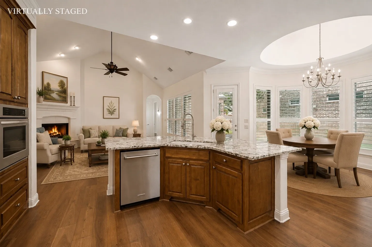 The gourmet kitchen is beautifully appointed with all-new stainless steel appliances, abundant custom cabinetry, granite countertops, a designer tile backsplash, a spacious center island with seating, and an open-concept layout that flows seamlessly into the breakfast nook and family room—perfect for entertaining and everyday living.