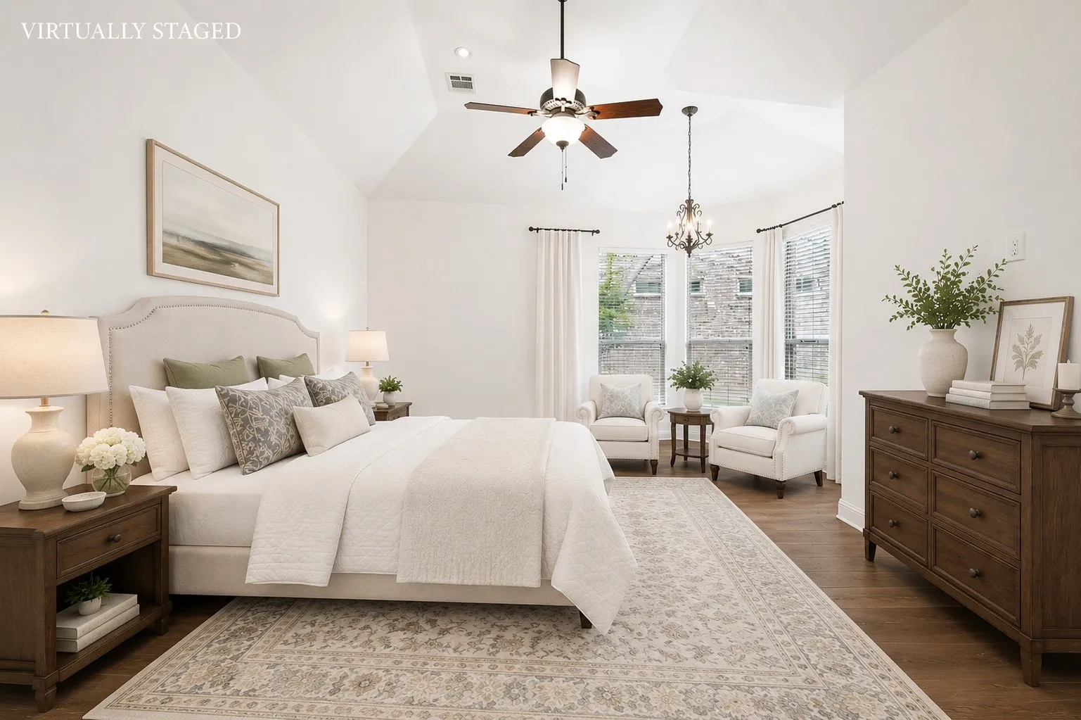 Escape to the spacious primary suite, featuring soaring vaulted ceilings, rich hardwood floors, abundant natural light, and a charming sitting area framed by beautiful bay windows. The private retreat offers direct access to the luxurious ensuite bath, creating the perfect space to relax and unwind.