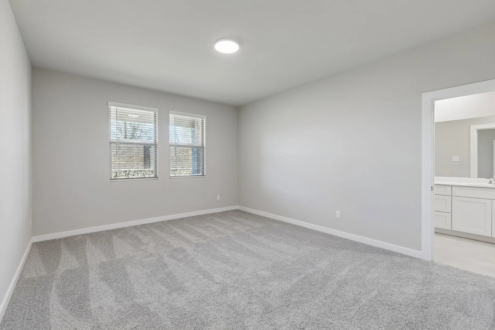 Primary Suite in the Holden home plan by Trophy Signature Homes – REPRESENTATIVE PHOTO