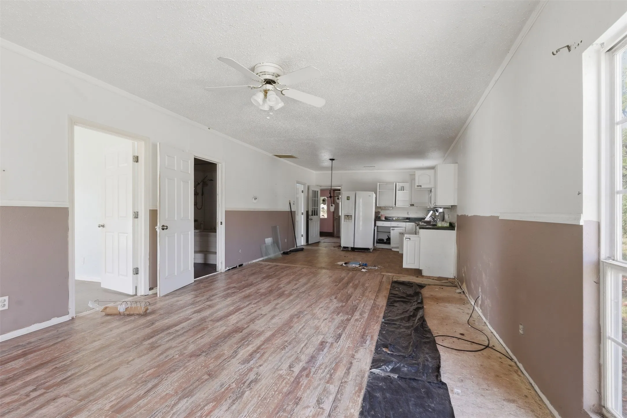 Front door view of living room and kitchen showcasing an open floor plan