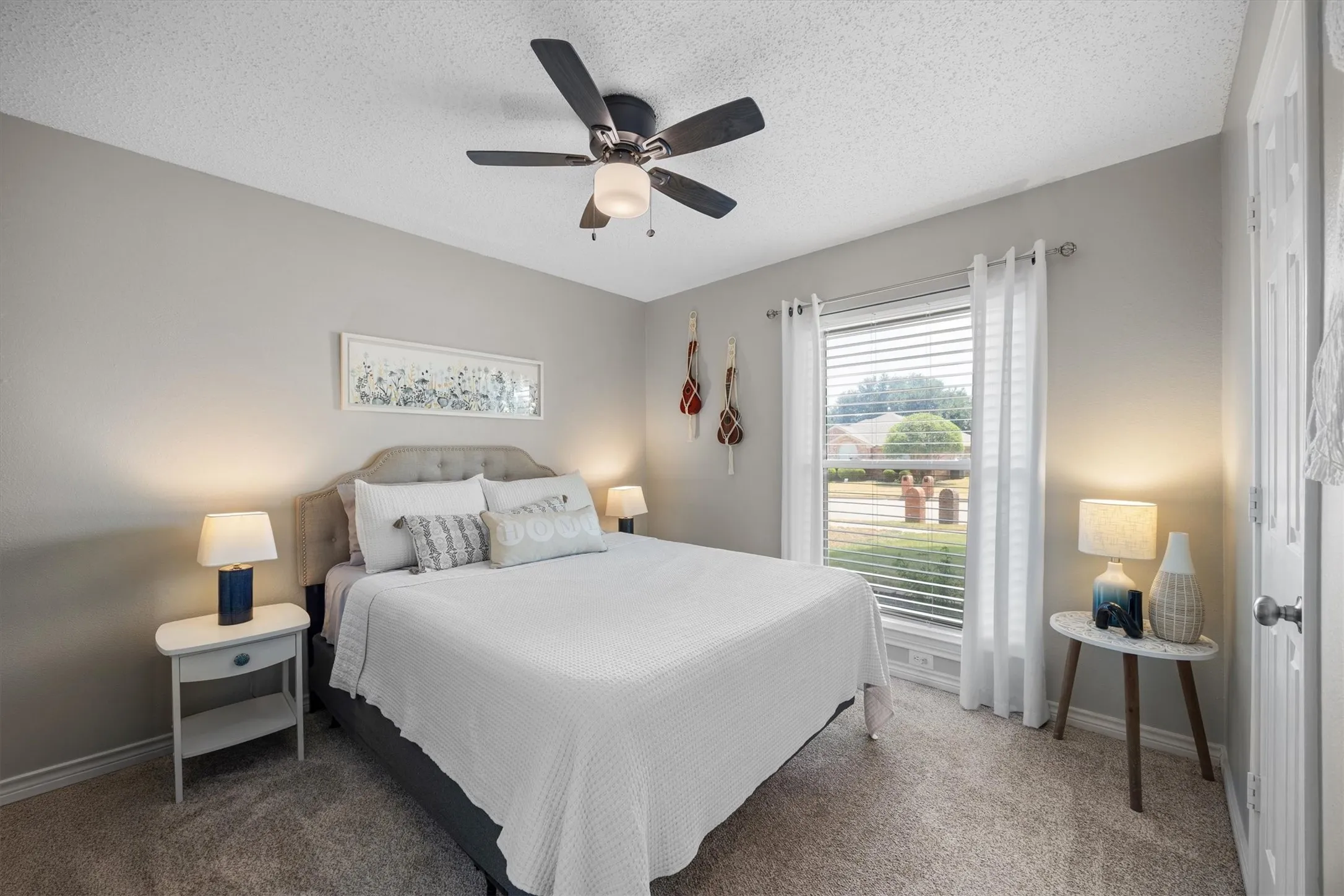 Neutral-toned walls, a ceiling fan with integrated lighting, and carpeted flooring. This 2nd bedroom is perfect for kiddos or guests.