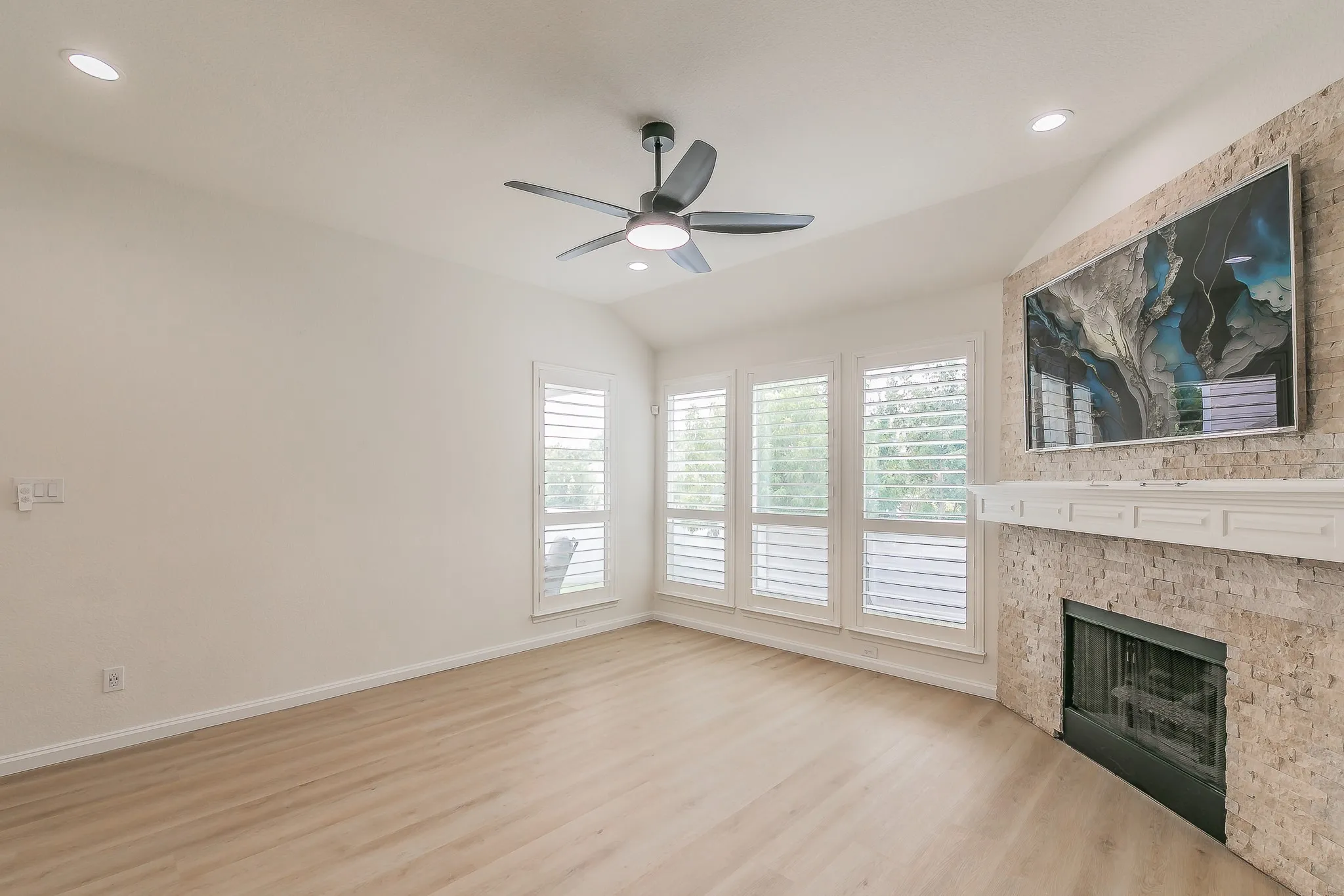 Large windows in the living room overlooking the private​​‌​​​​‌​​‌‌​‌‌​​​‌‌​‌​‌​‌​​​‌​​ backard