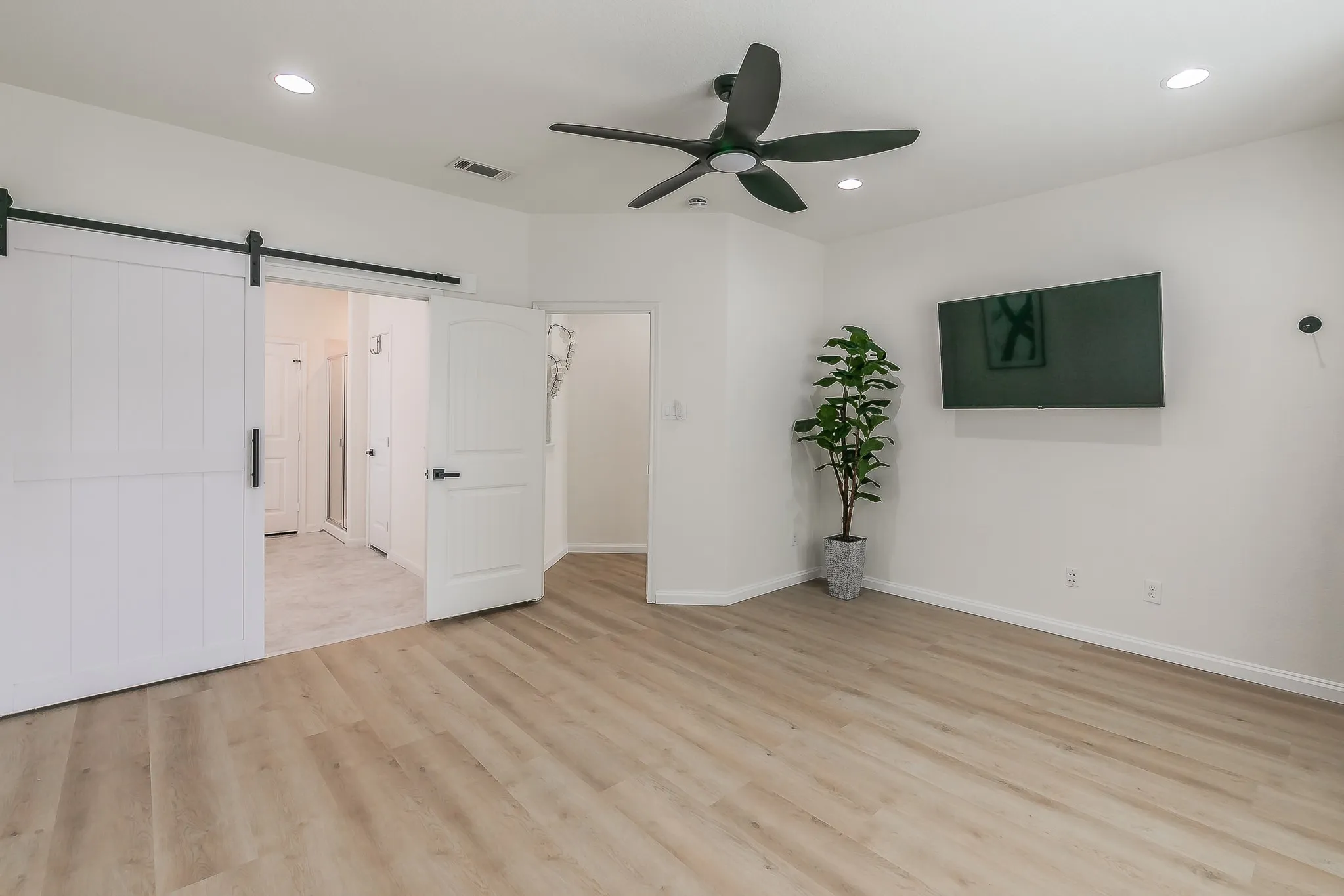 Barn door into the primary bathroom