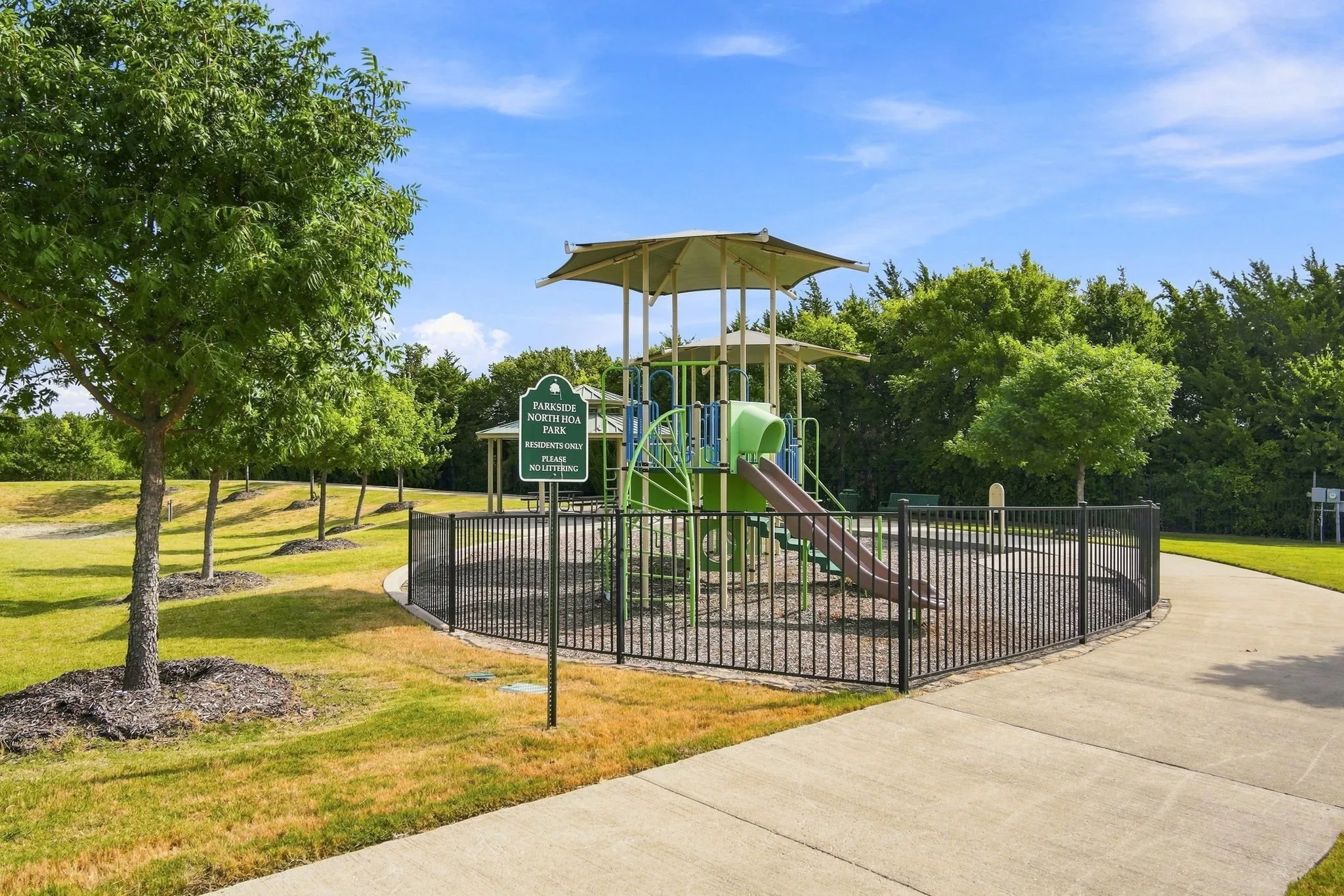 No need to build your own when you can step outside and enjoy this playground and green space with gazebo