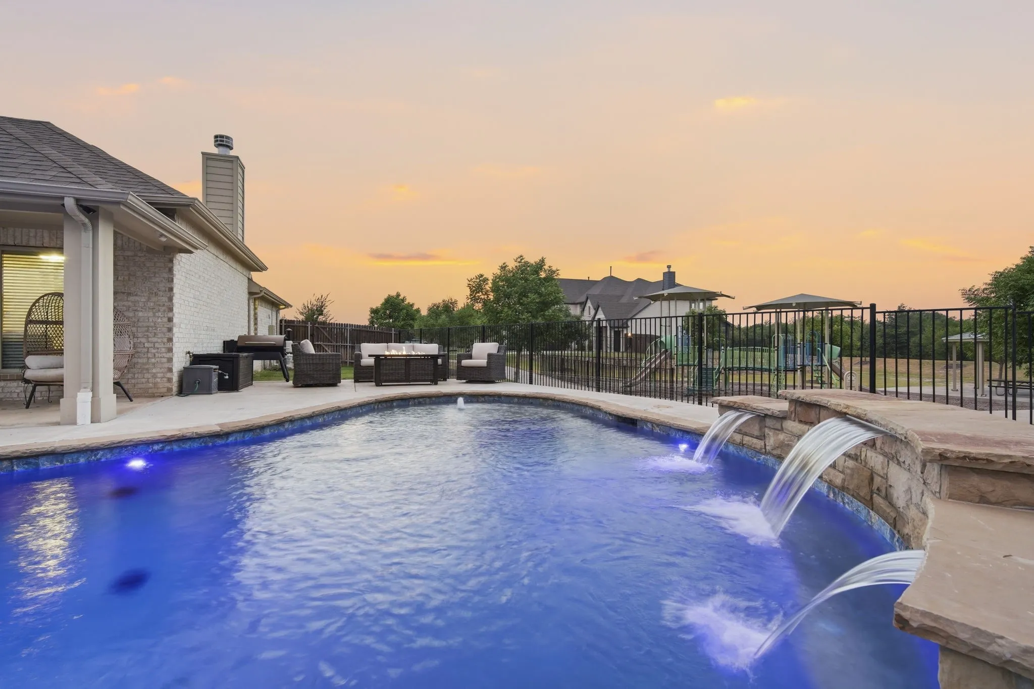 This property showcases a spectacular new inground pool with a sheer descending waterfall and sundeck with bubbler, creating your own private backyard resort