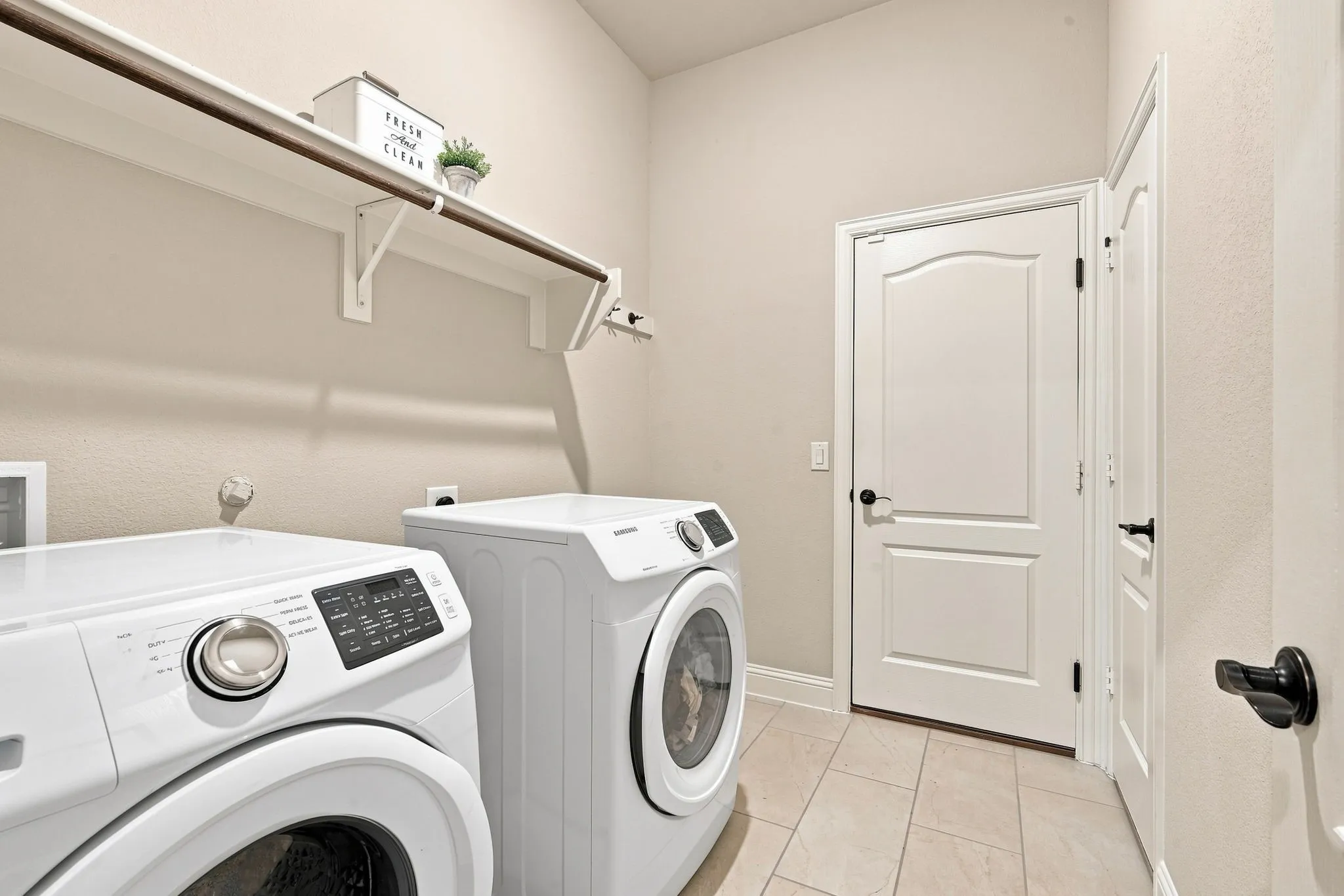 A separate laundry room hosts built-in mudroom storage