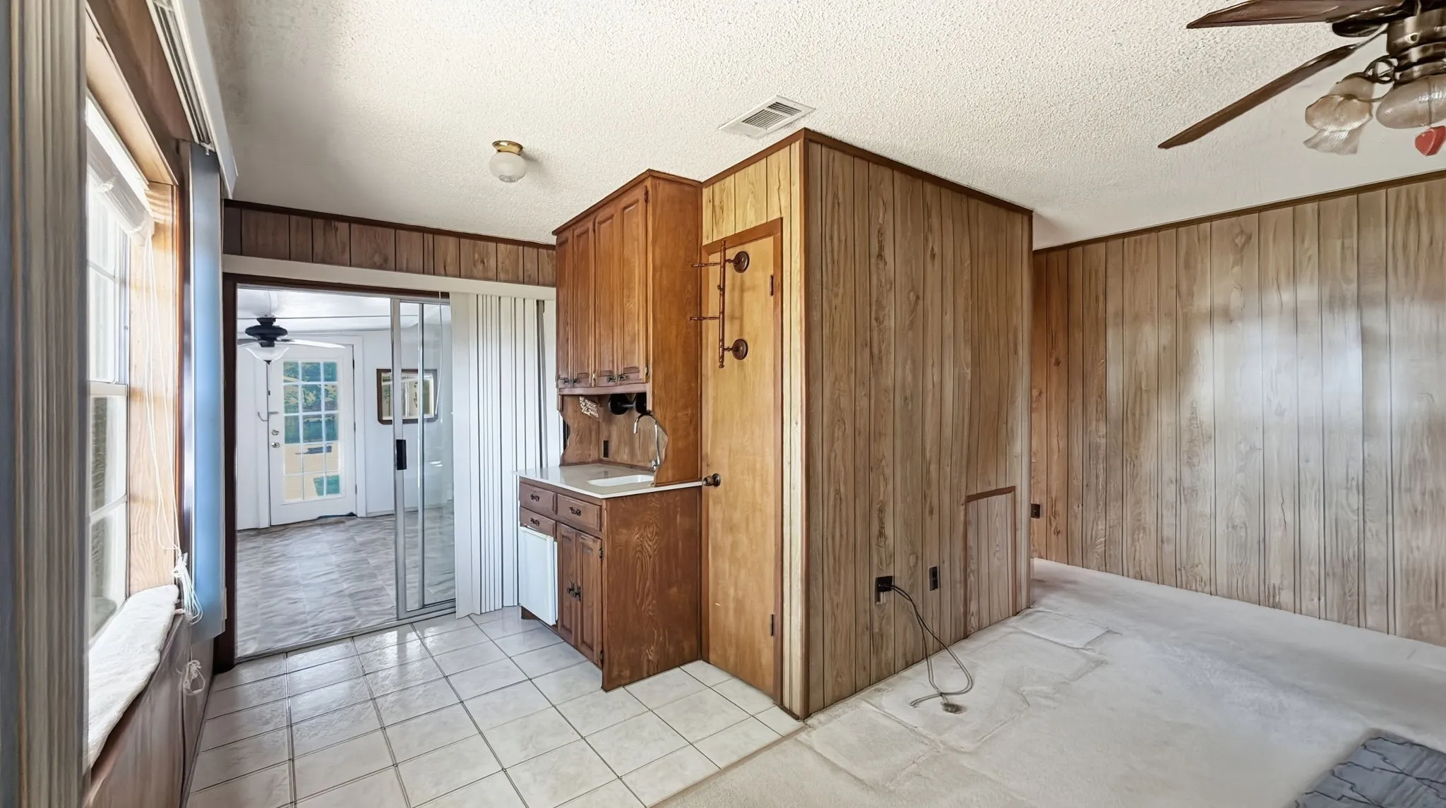 entrance to Mud Room with builtin cabinet-bar area