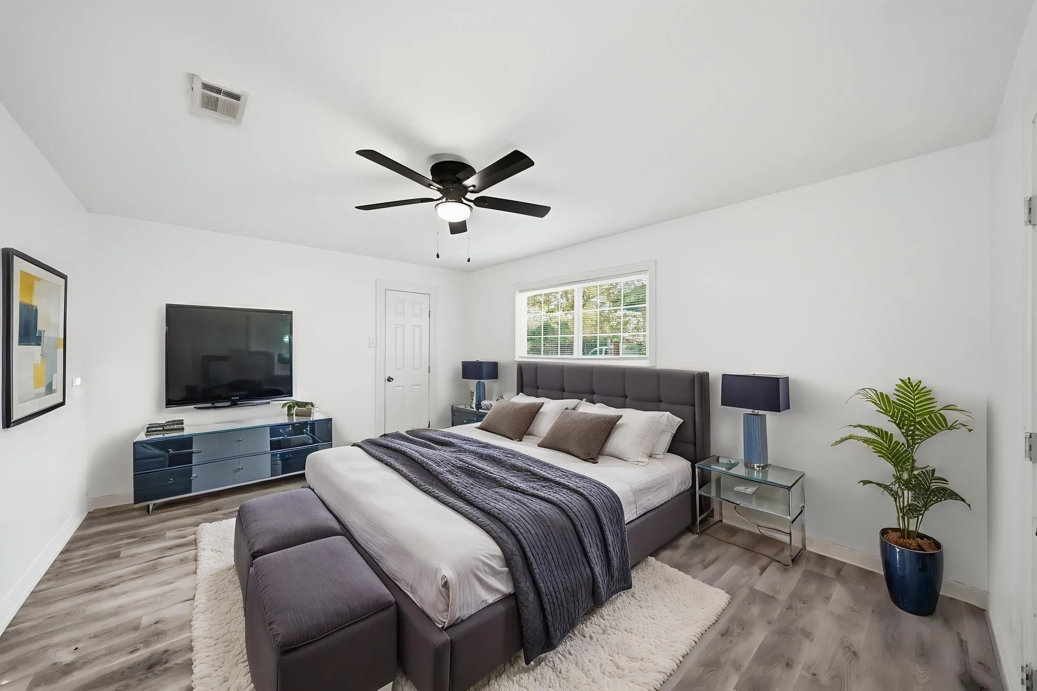 Light wood-finish flooring with white walls