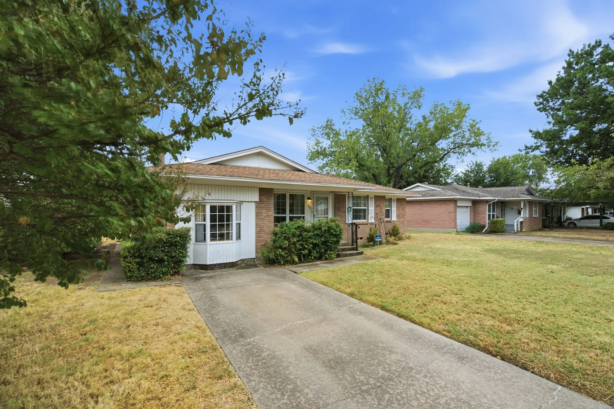 Front of house and driveway of 300 Parkwood Place, Lewisville, TX in Lakeland Terrace