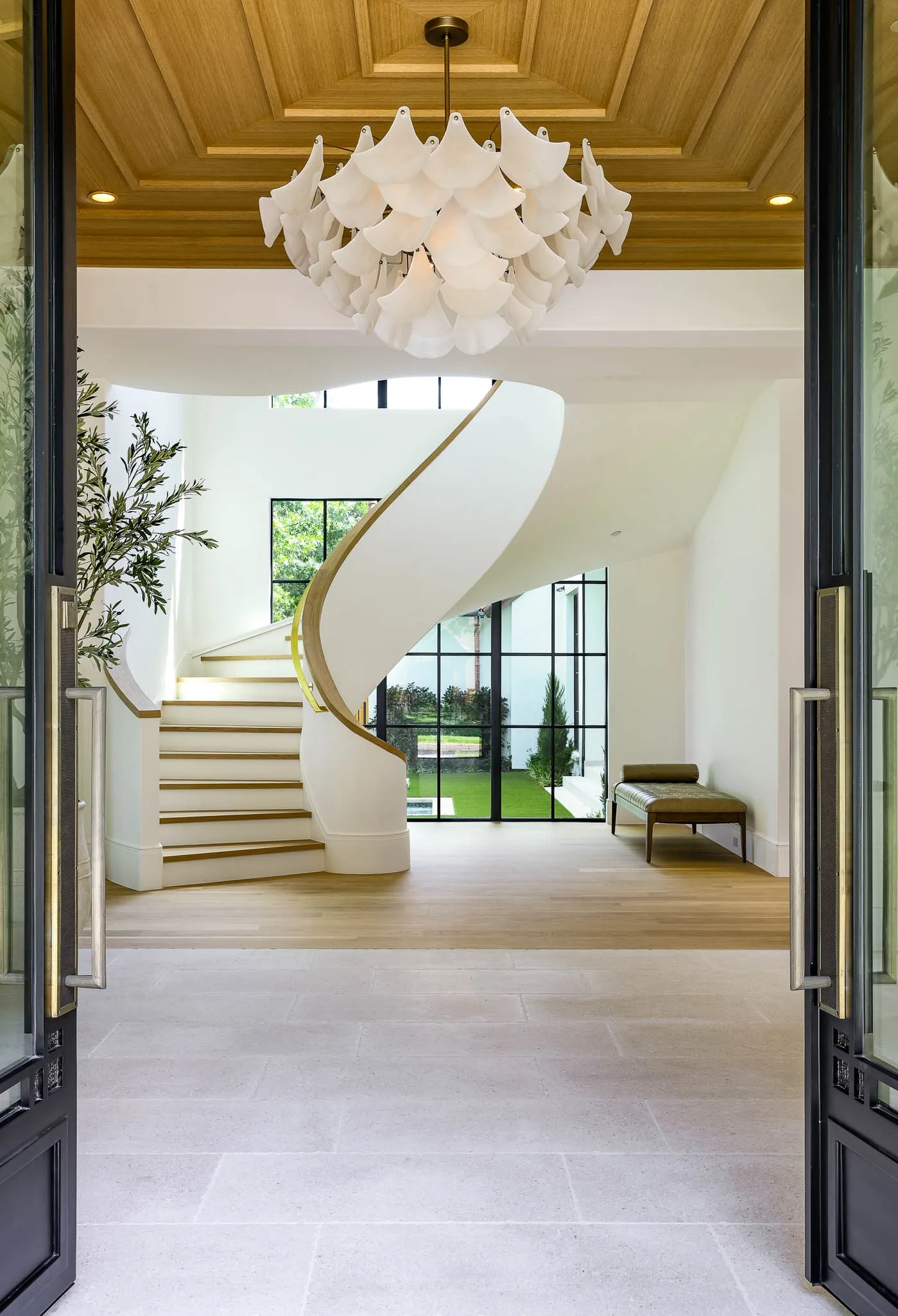 Gracious formal entry with floating staircase, custom ceiling design, and Bella Figura Lyra chandelier