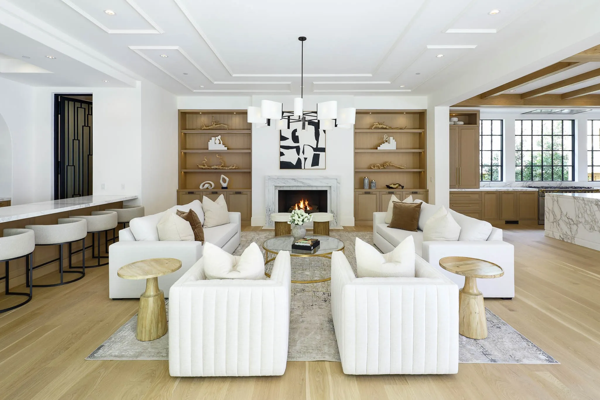 Family Room with gas fireplace and custom built-ins open to Formal Bar, Wine Room, and Kitchen