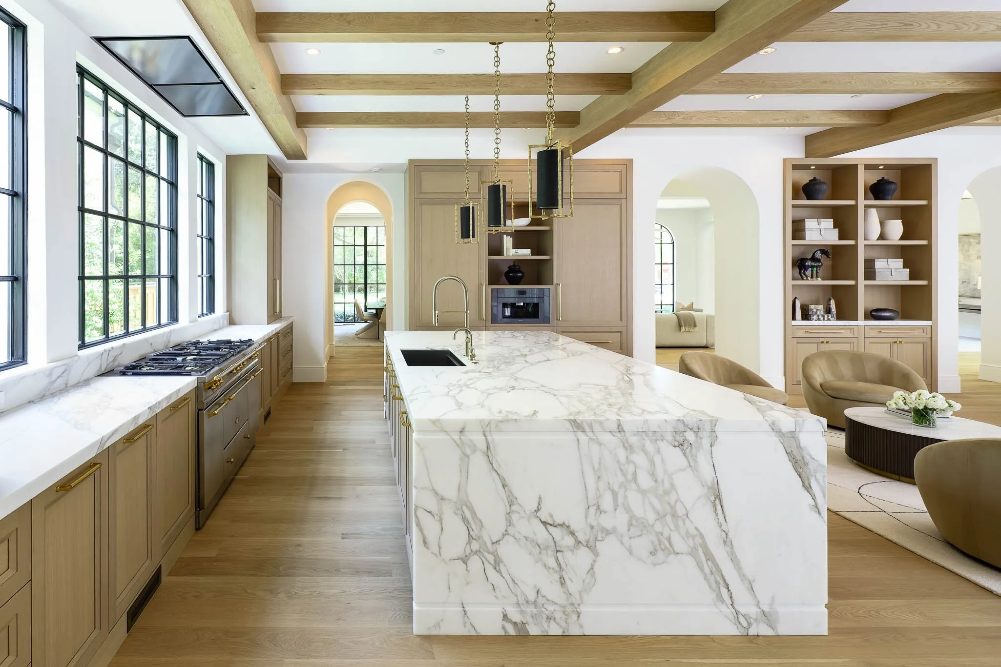 View of Kitchen island with marble slab countertops into the Morning Room