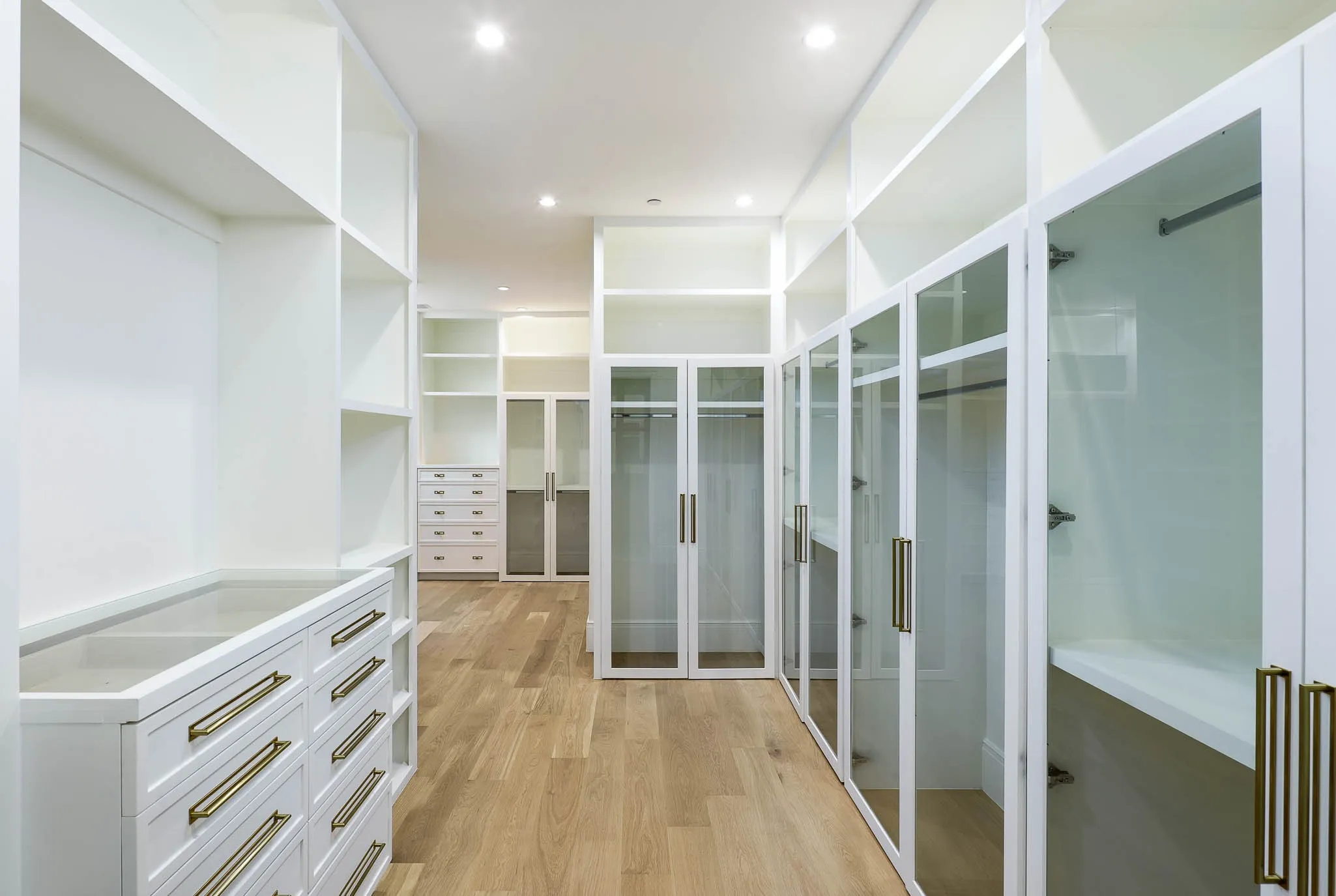One of two expansive boutique style custom closets