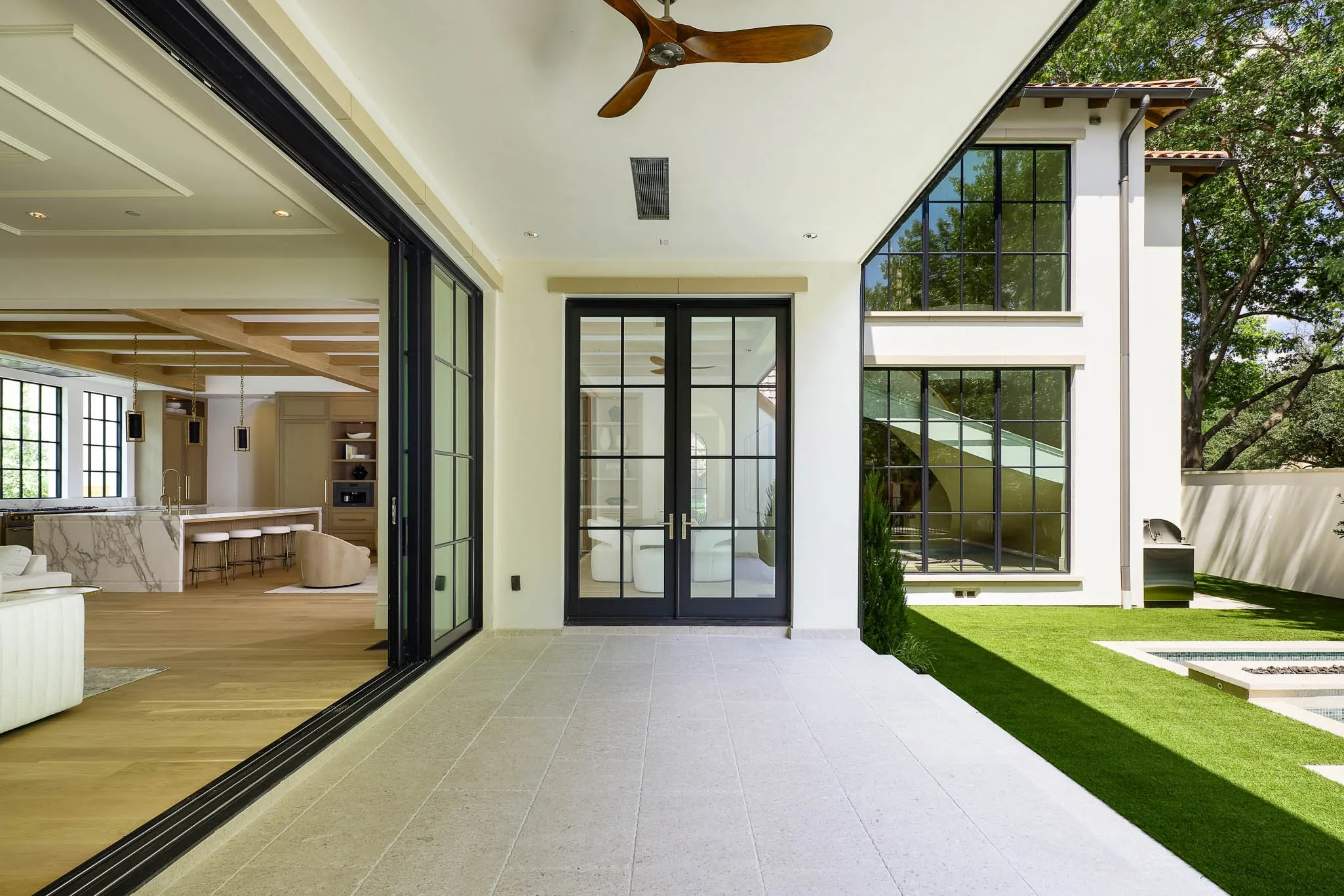 Outdoor climate controlled Loggia with retractable screens overlooking pool and turfed yard