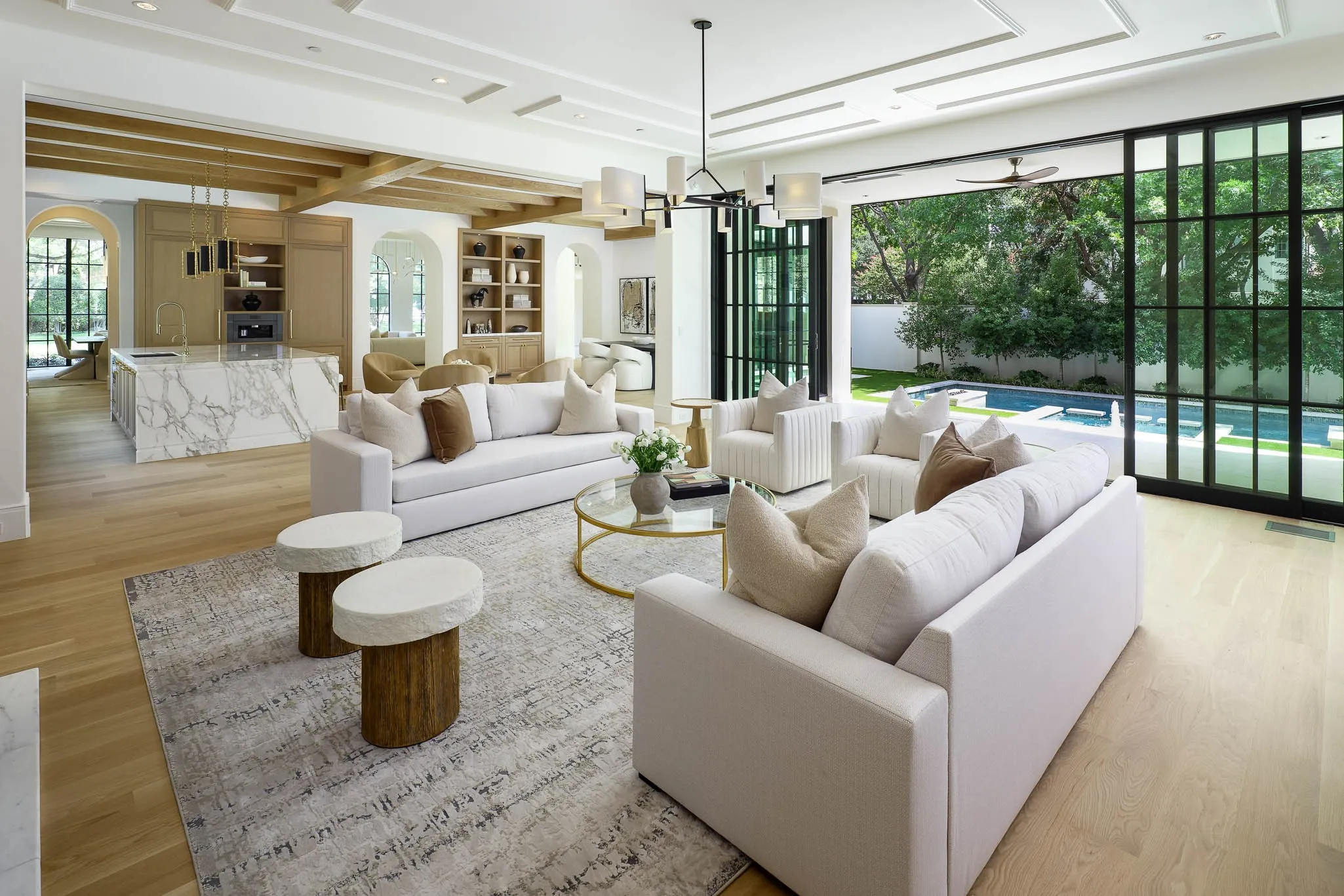 View of Family Room and climate controlled outdoor Loggia with automated retractable screens beyond