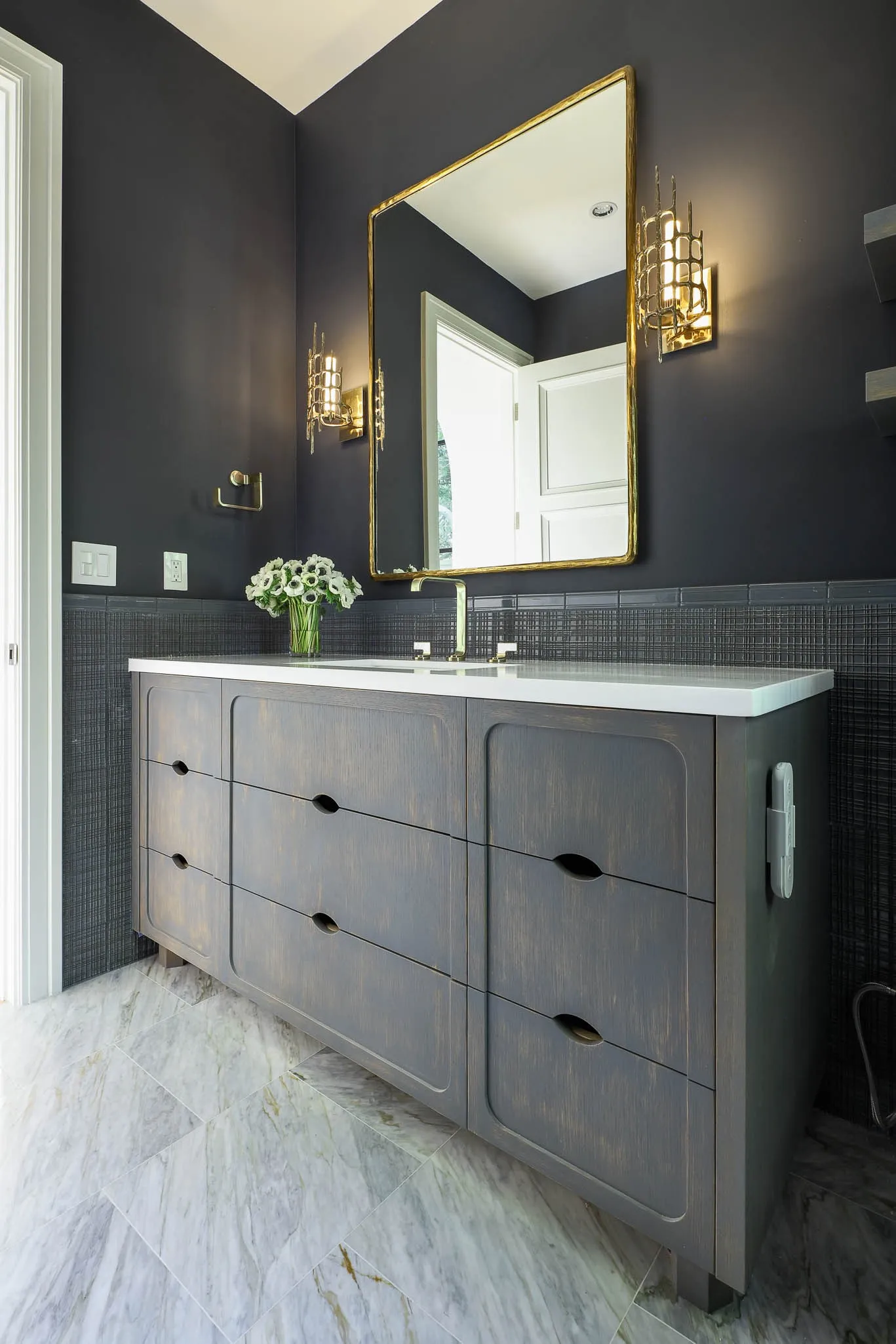 Downstairs Powder Bath with marble flooring and wainscoting, Holly Hunt lighting, Kallista plumbing fixture