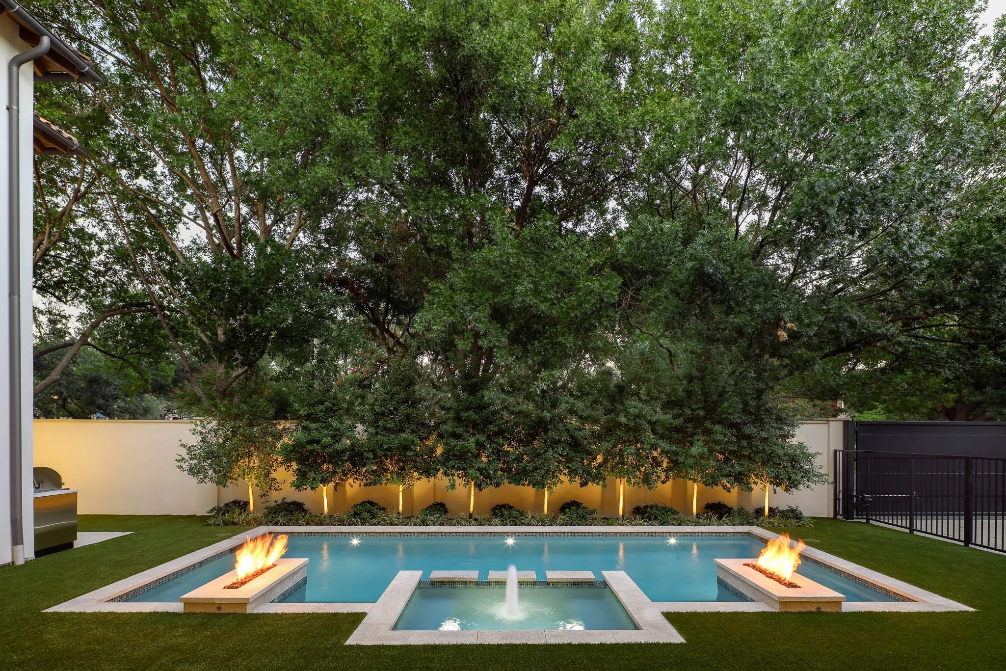 Heated chlorine 30x14 ft pool and spa with glass mosaic tile and linear fire accents