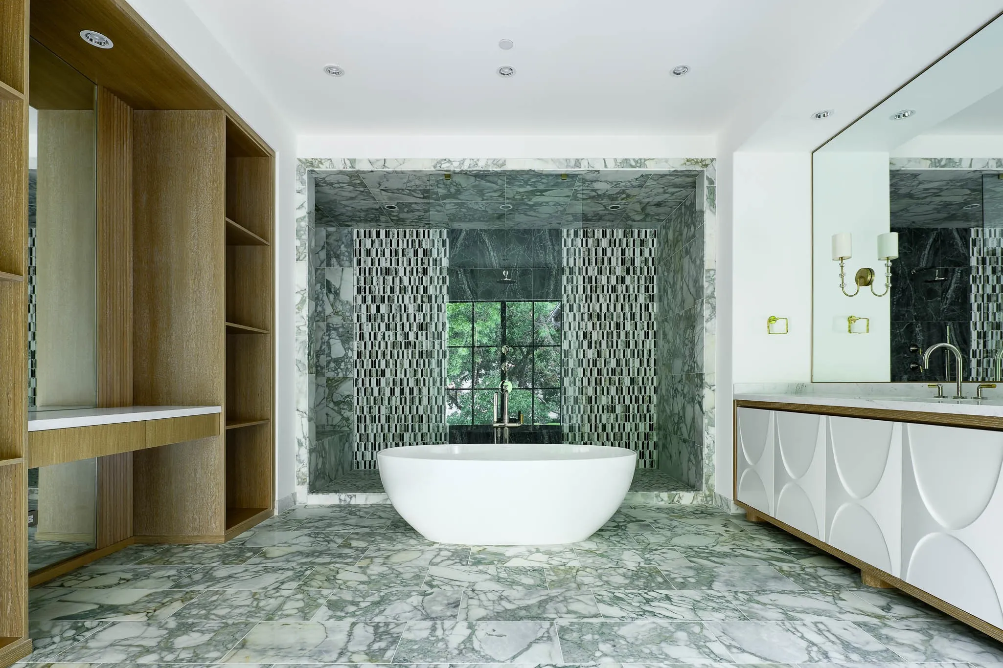 One of two spa baths featuring marble flooring and tile, Kallista plumbing fixtures, vanity area, and oversized deep soaking tub and shower