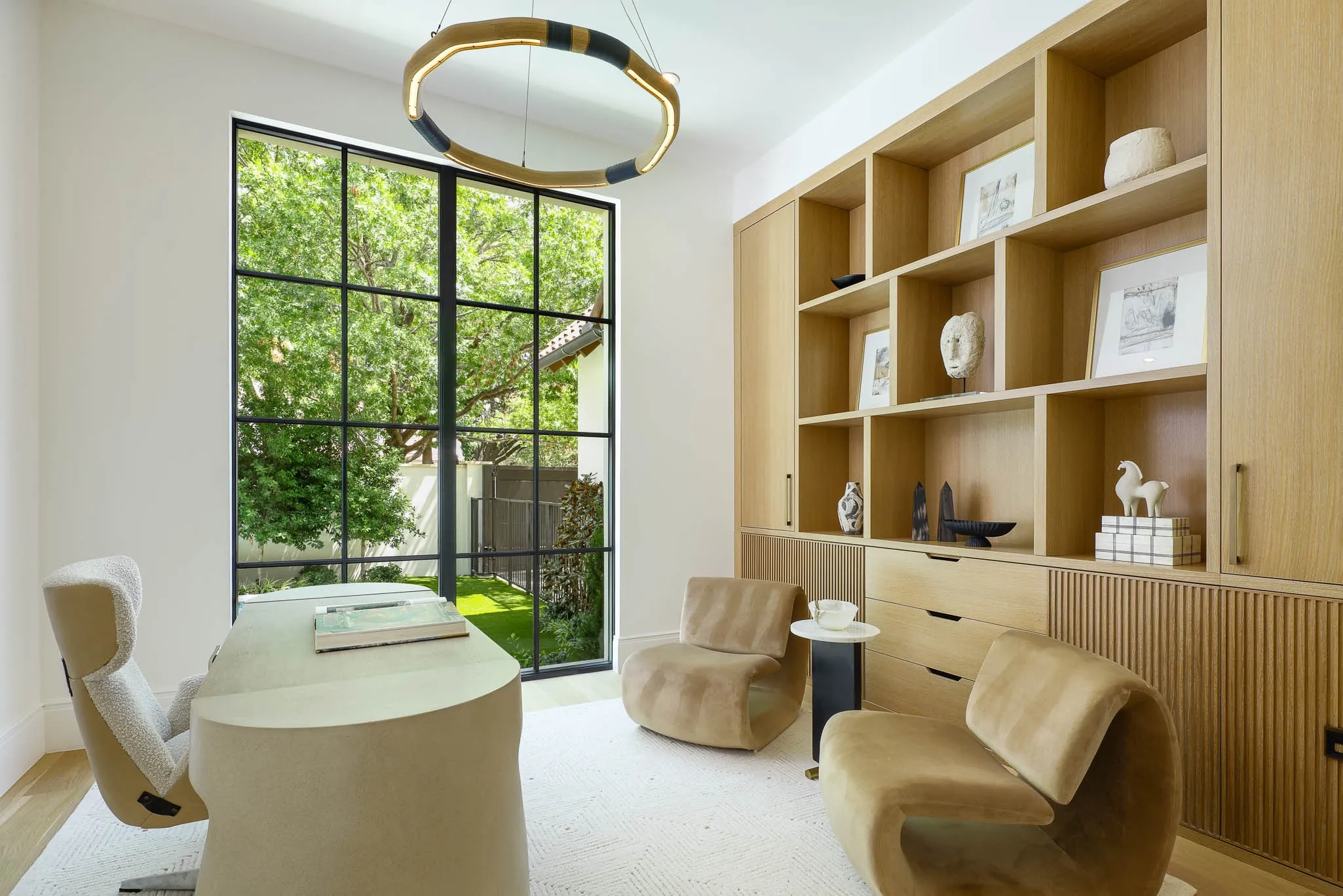 Downstairs Formal Study with custom built-in cabinetry and steel doors for privacy