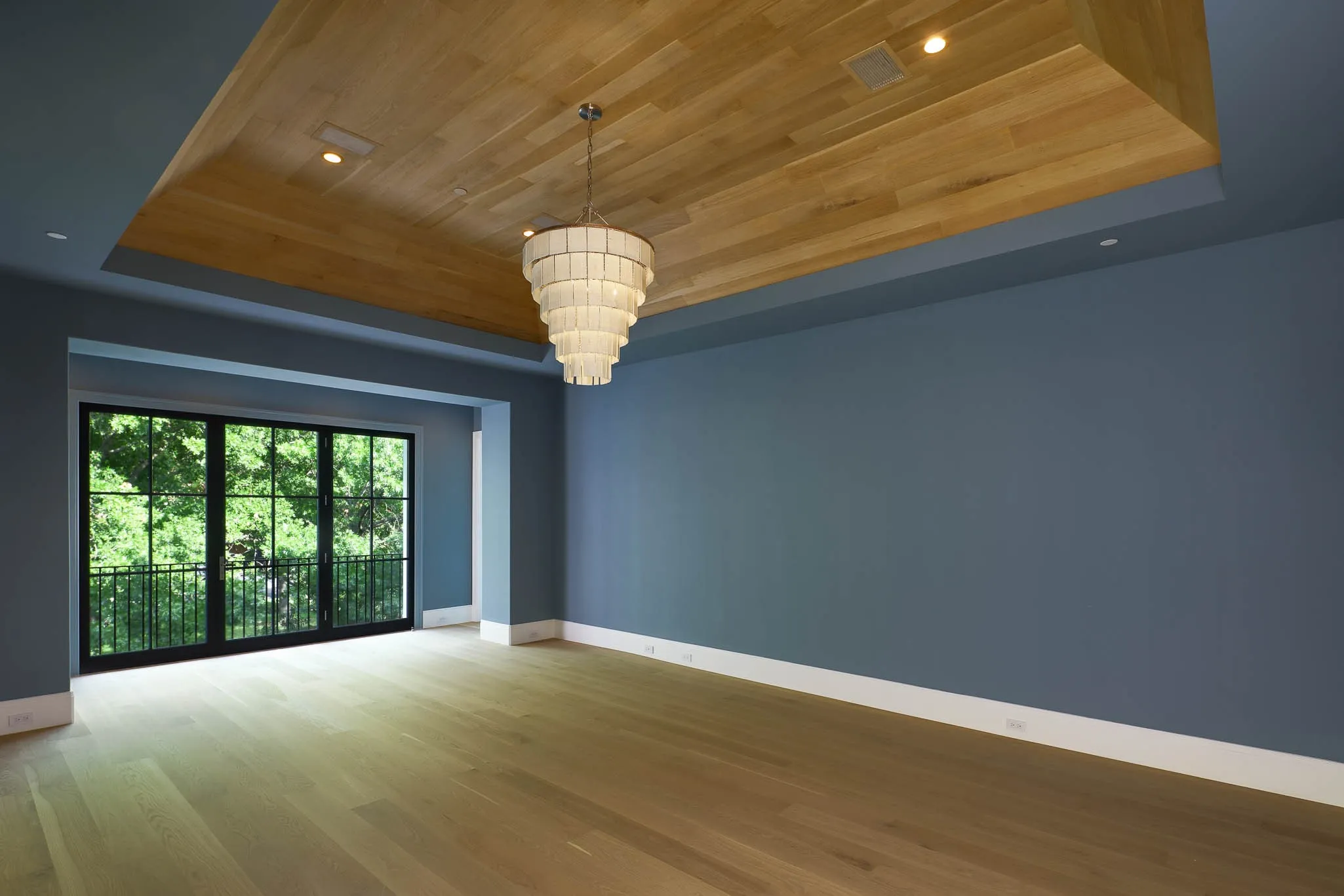 Primary Suite with vaulted ceiling, juliet balcony overlooking the pool and spa, and two spa baths with boutique style walk-in closets