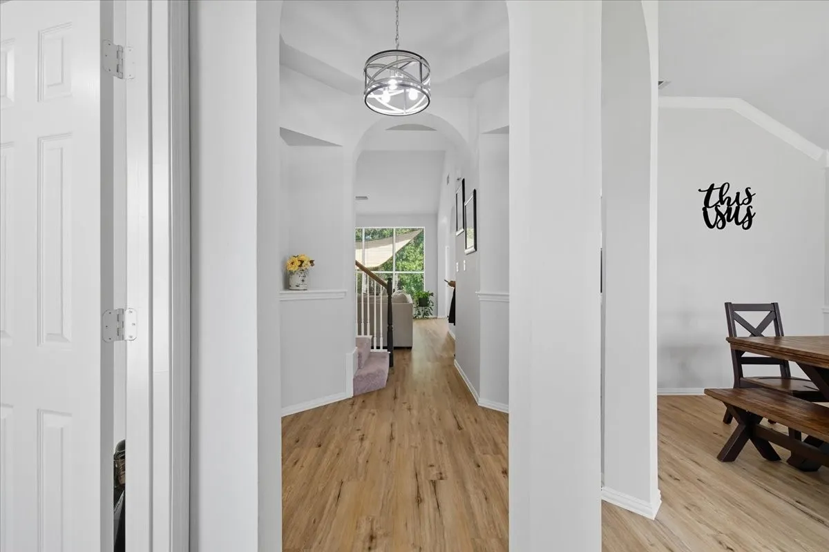 Wood-finish flooring throughout, framed by light gray walls