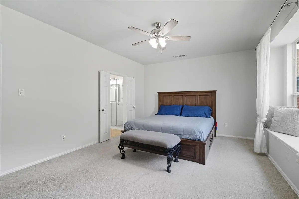 Carpeted flooring, ceiling fan, window bench, French doors, and built-in window seating